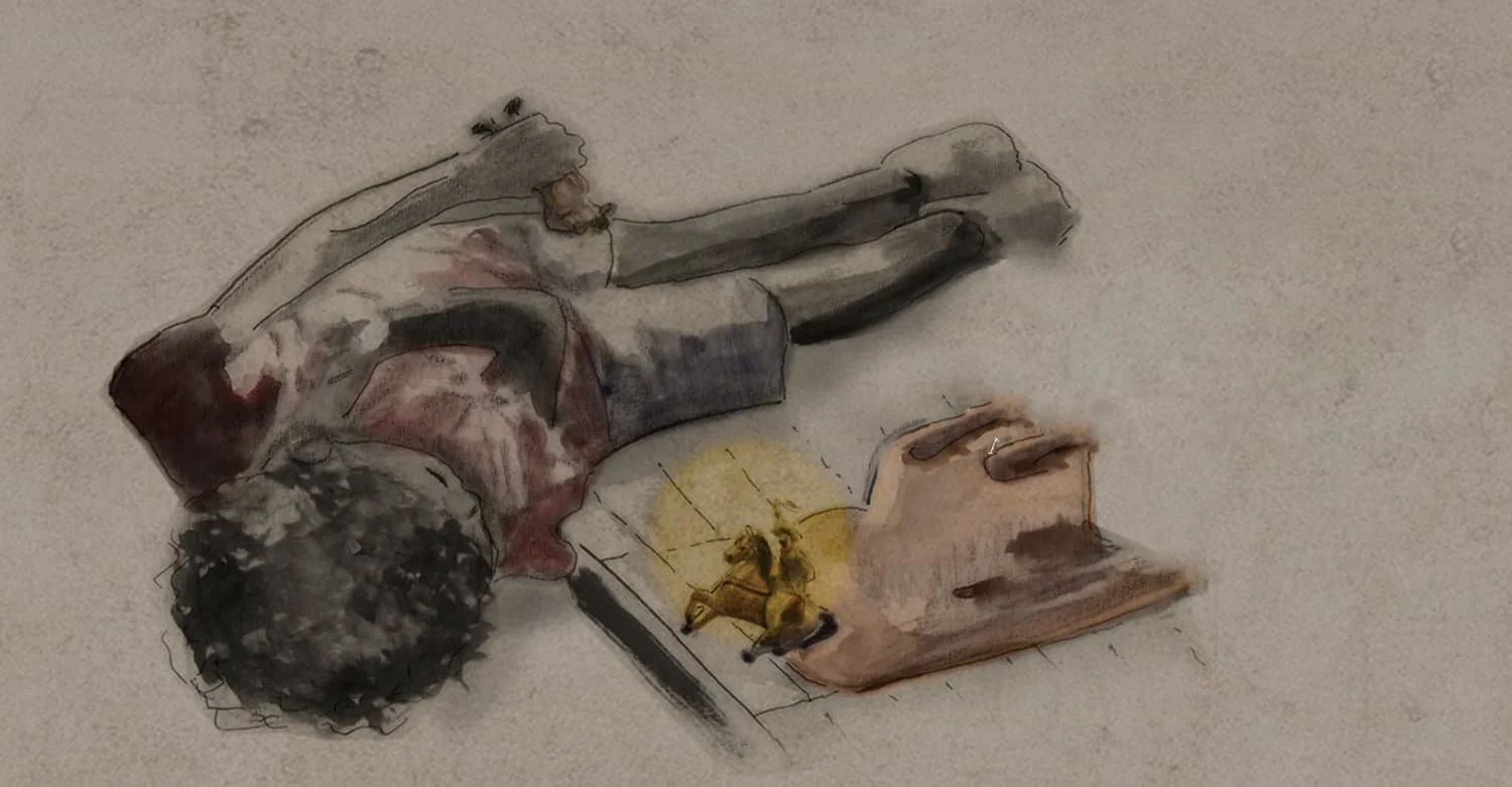 A person with curly hair lying on the floor reading a book with a lamp nearby. Costume supervision by Keagan Roberson.