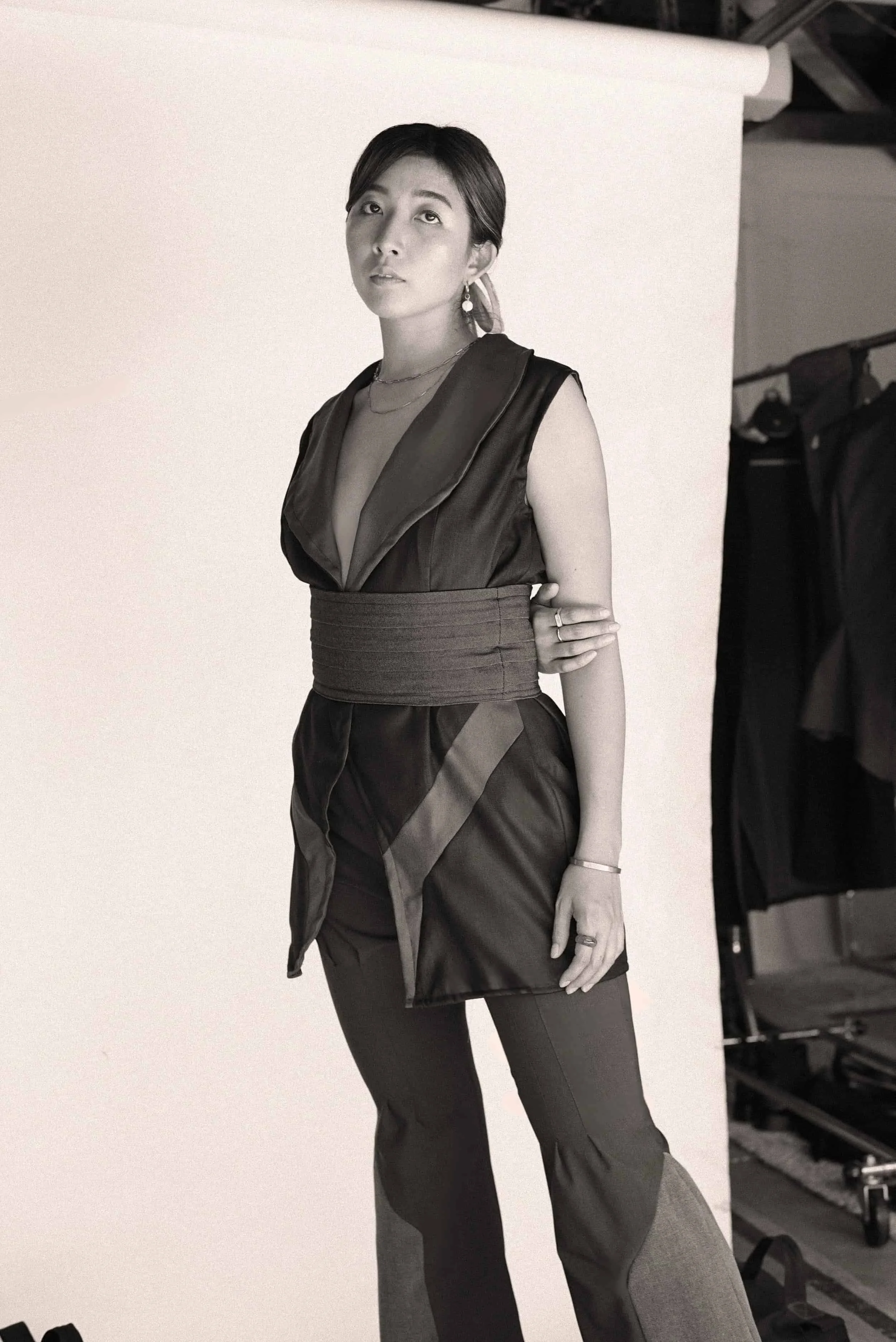 Model wearing a deep-neck sleeveless top and two-tone trousers from Keagan Roberson.