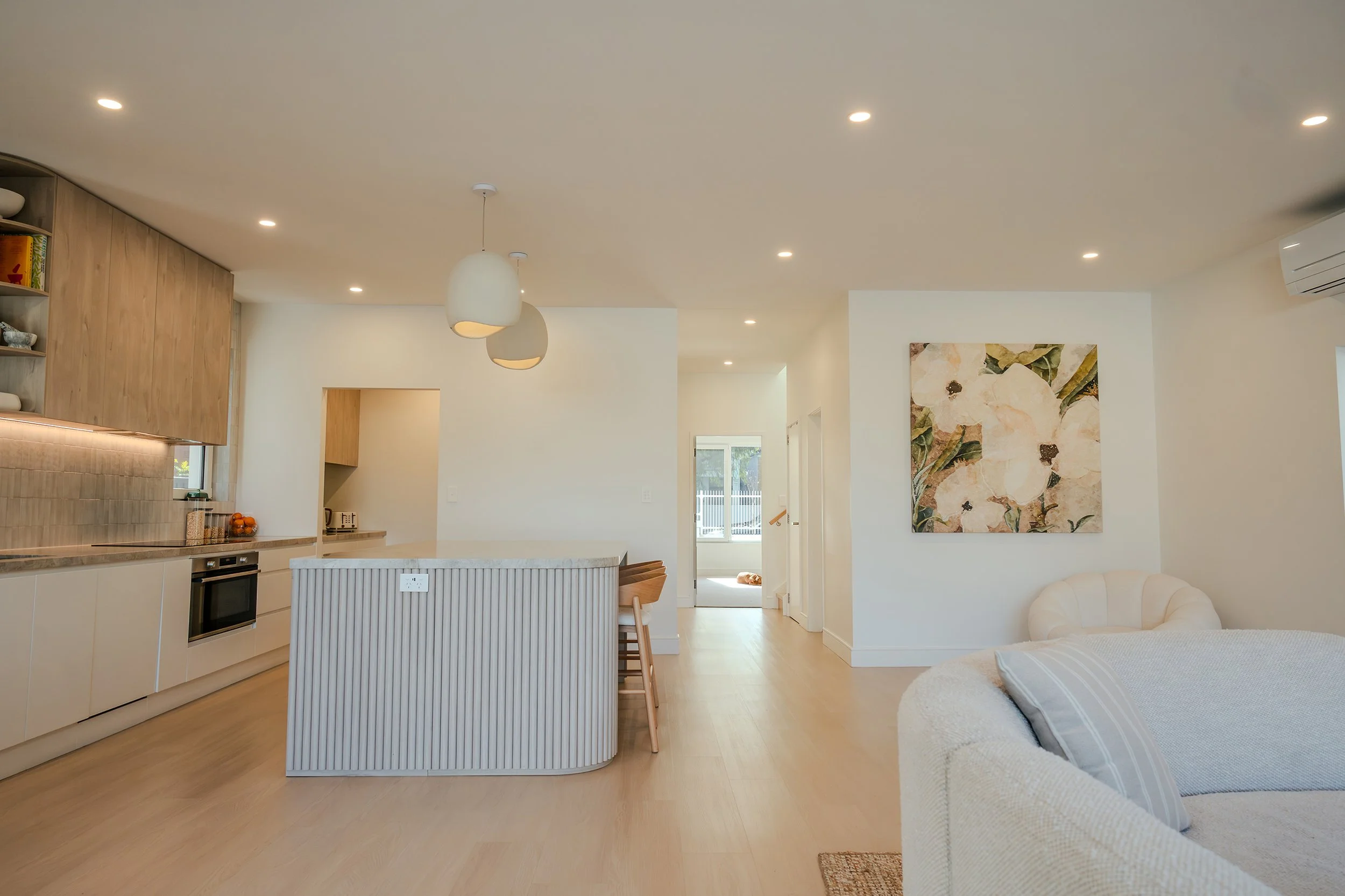 Open-plan kitchen and living space in a modern Sydney Passivhaus home showing clean lines and natural light