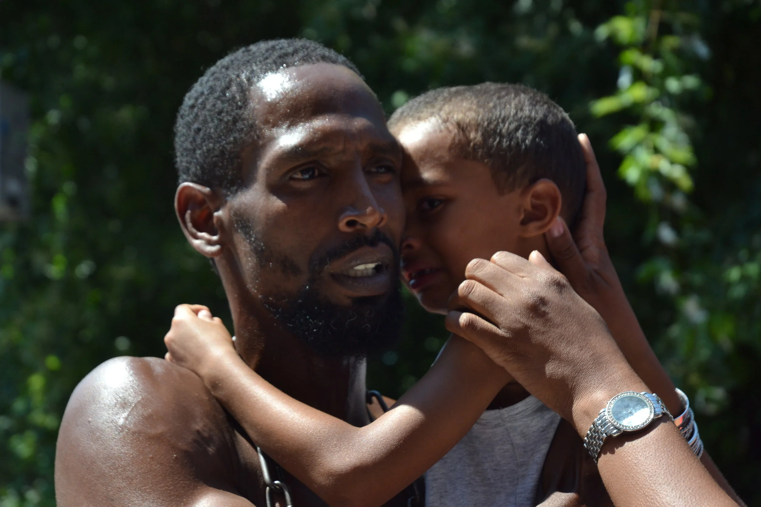 This is a photo of a father who is being reconciled with his child. When you leave your country, you never know when you’re going to see your child again.