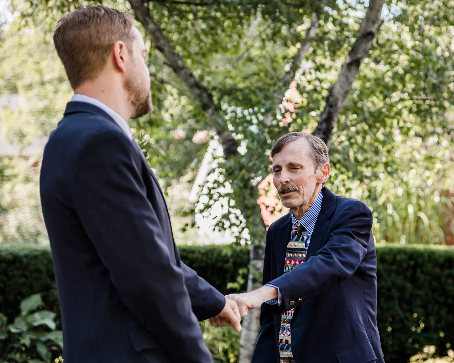 groom-and-father-first-bump-before-wedding-ceremony.jpg