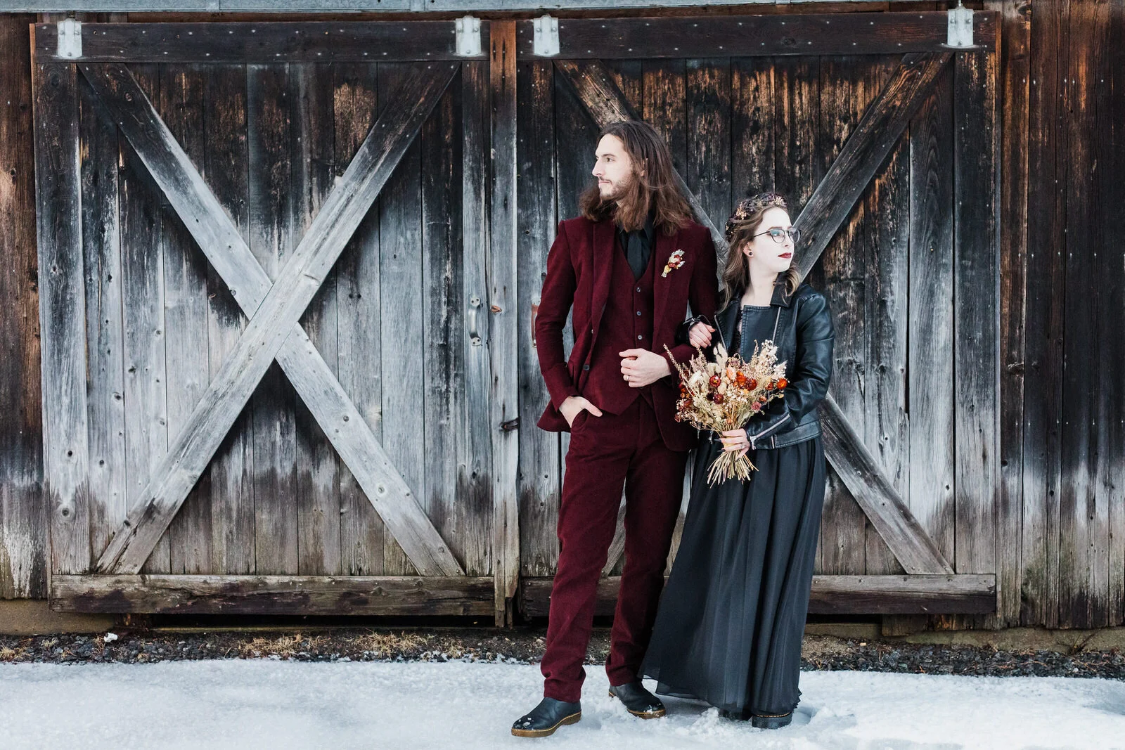 edgy-elopement-couple-outside-by-barn-doors-winter-vermont.jpg