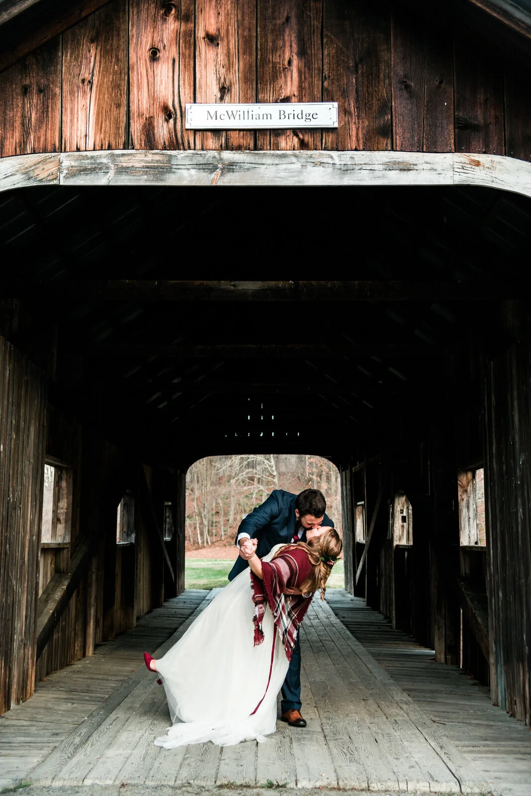 couple-dipping-and-kissing-on-covered-bridge-vermont.jpg
