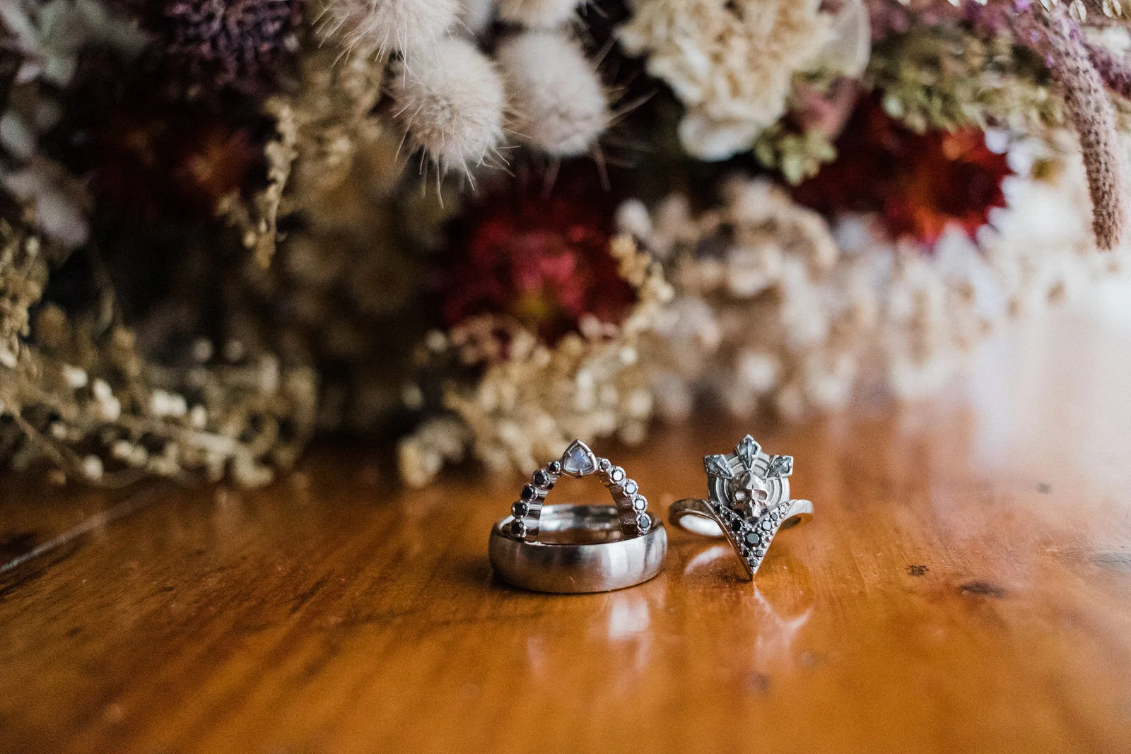 unique-wedding-rings-by-dried-floral-bouquet.jpg