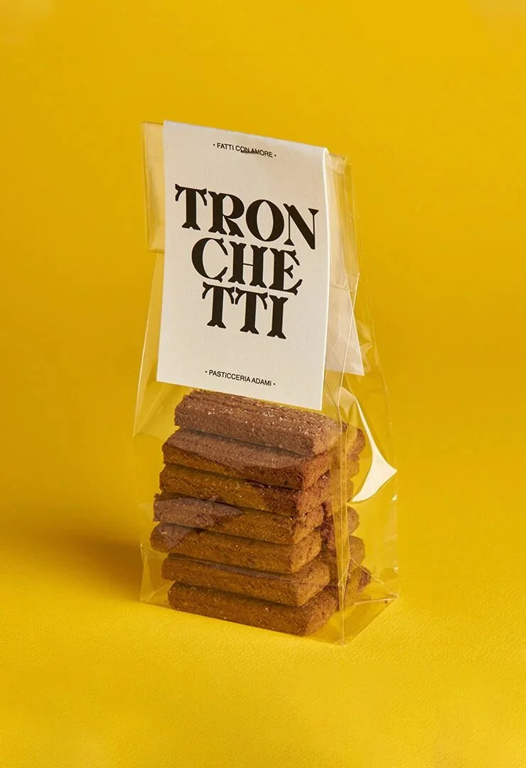 Packaged stack of rectangular cookies with a label reading 'TRONCHETTI' against a yellow background.