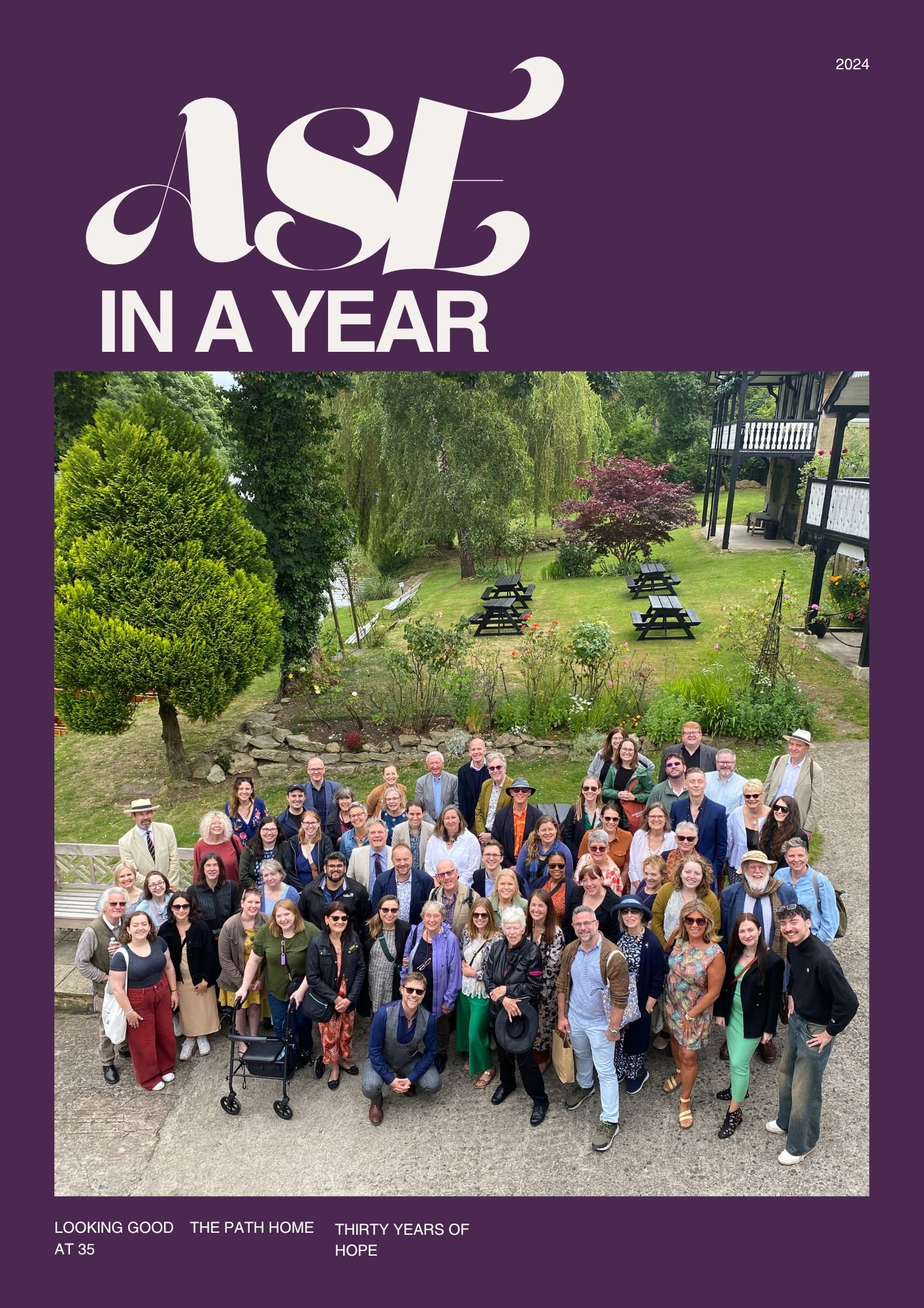 A group of people gathered outdoors in front of a garden and house for a photo, celebrating thirty years of Hope at The Path Home, 2024.