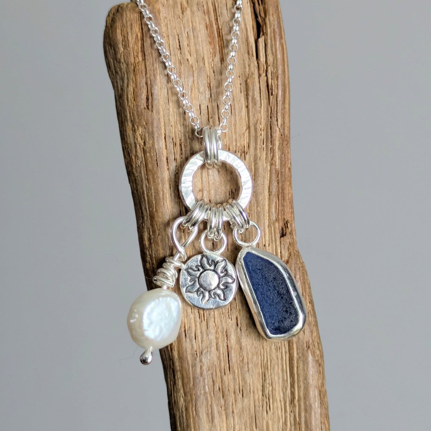 Seaglass, Pearl and sun/moon disc charm necklace. Available on the website. This is actually quite a dainty piece 💕

#seaglass #pearl #recycledsilver #handmadejewelleryuk
