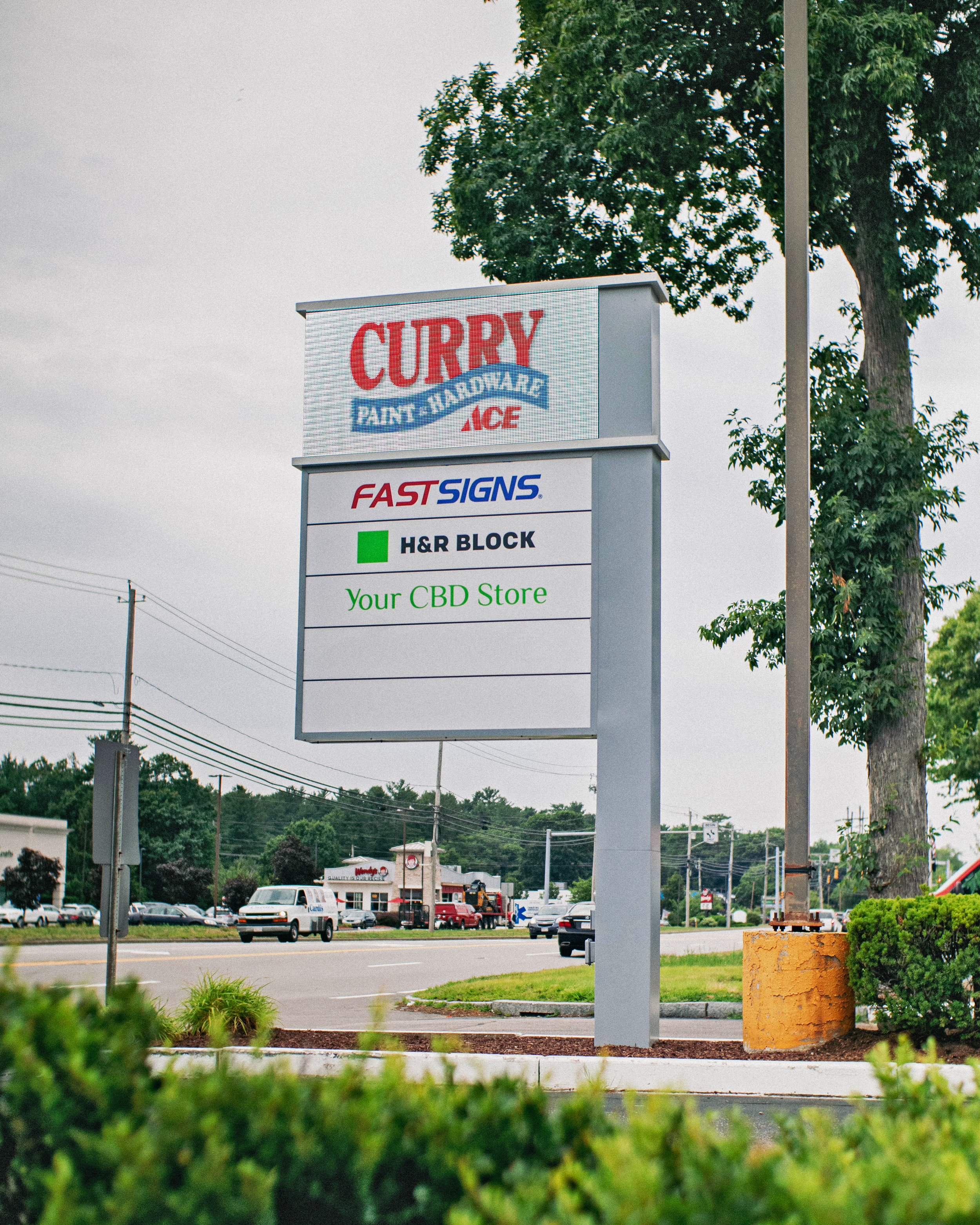 Freestanding pylon sign with multiple tenants, Curry Hardware, H&R Block, Your CBD Store