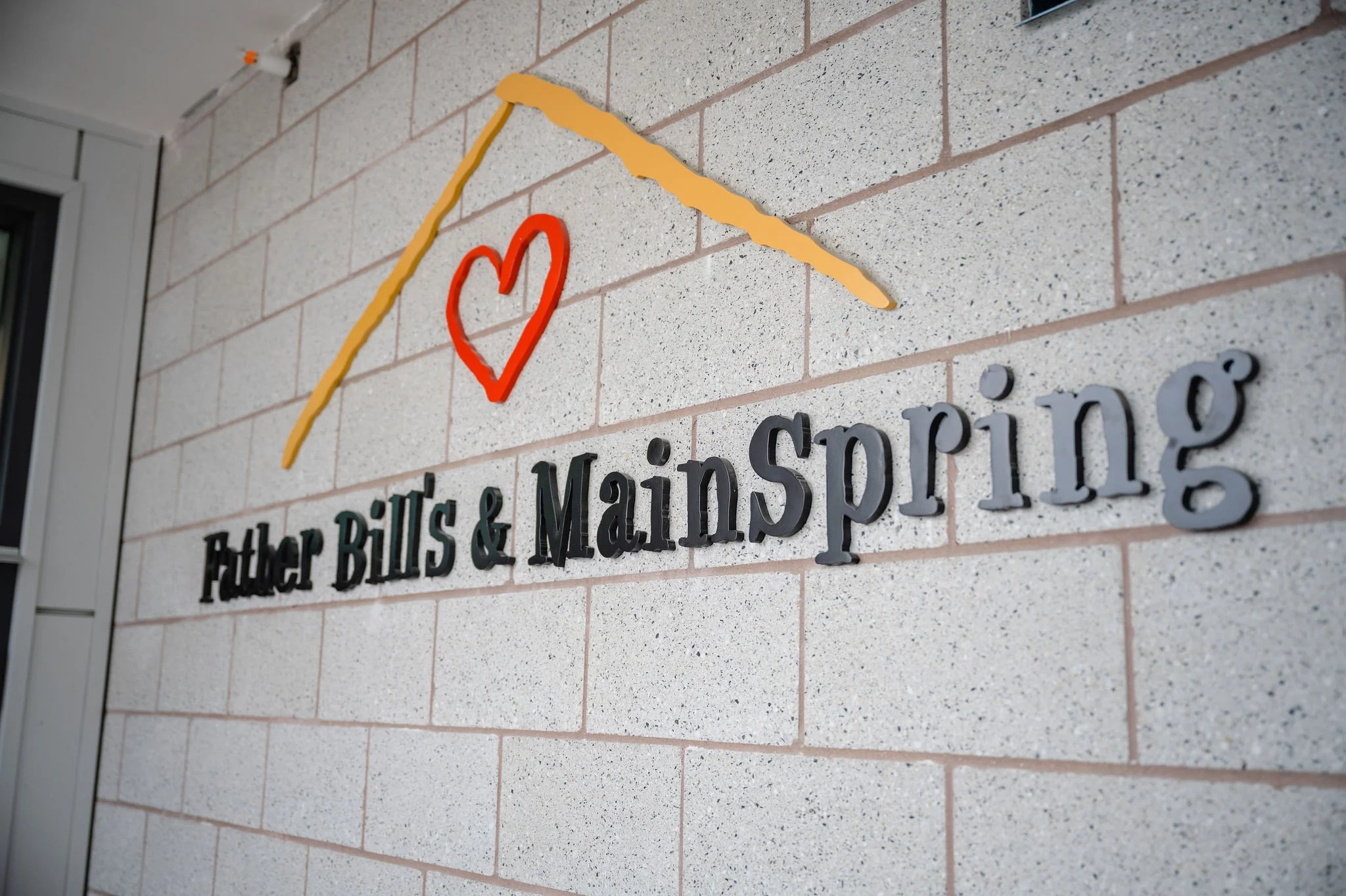 Close-up of large 3D black letters spelling 'SDG' on a white surface.