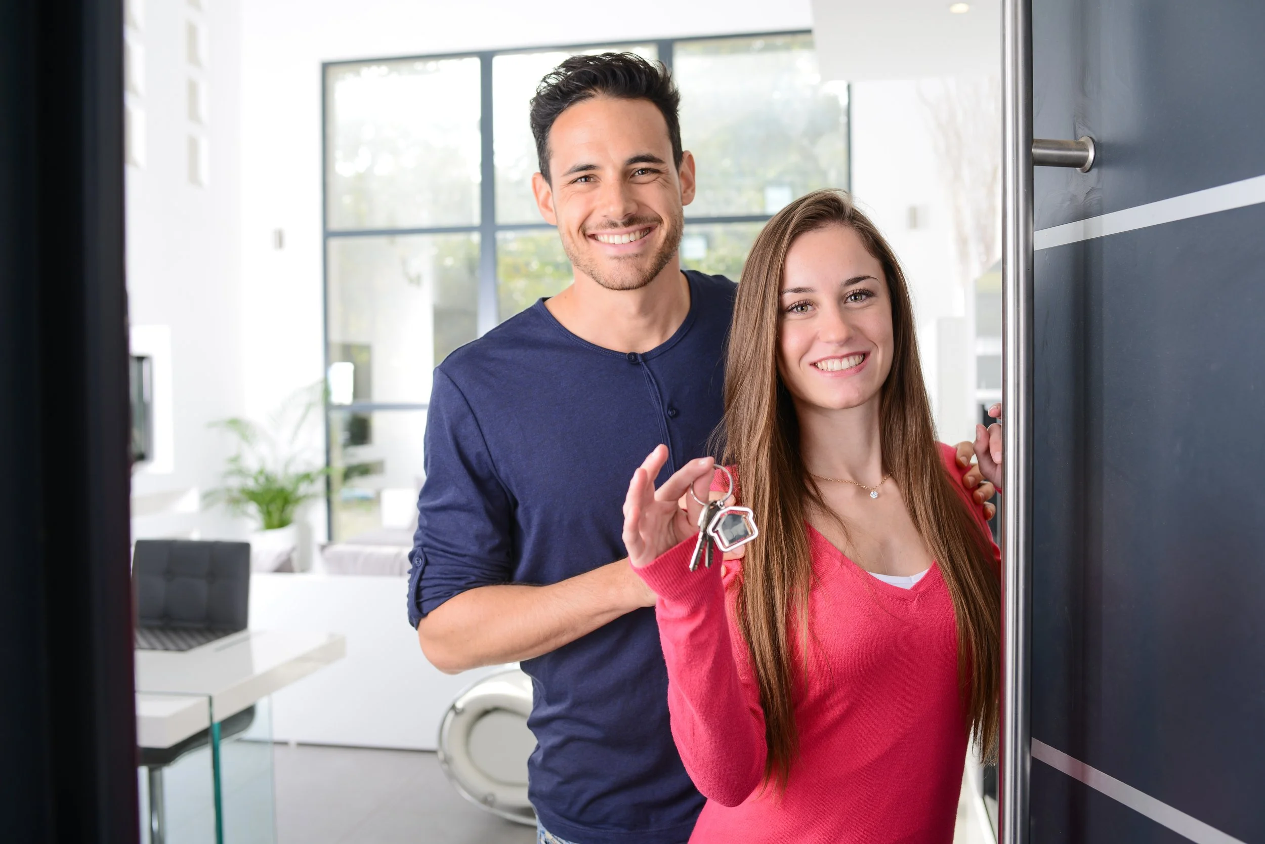Young first-time buyers holding the keys to their new home in Dunoon, Argyll
