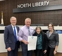 JCUNA members accept 2024 UN Day Proclamation from North Liberty Mayor Chris Hoffman.