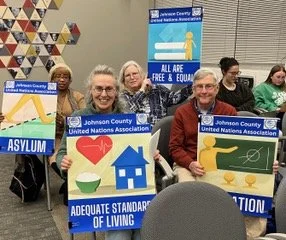 JCUNA members at the December 2024 meeting of the Iowa City City Council meeting where Mayor Bruce Teague issued a proclamation declaring December 10 as Human Rights Day.