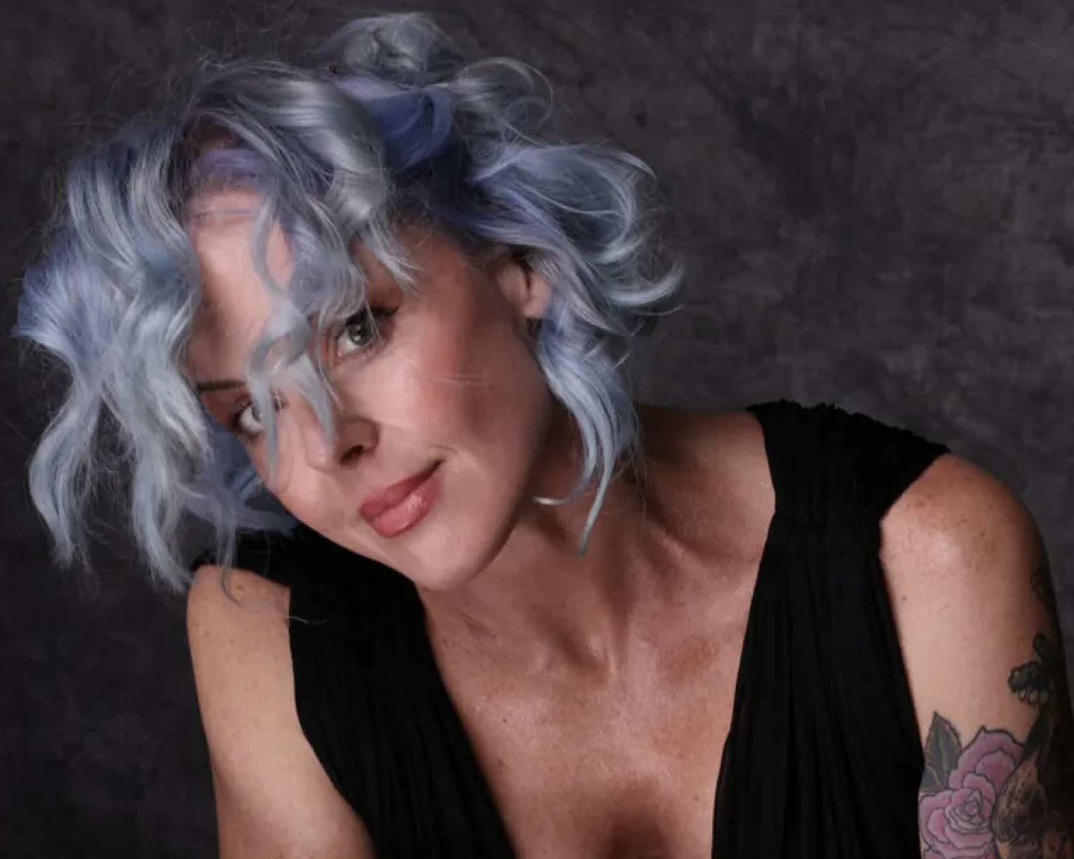Pearl District Portland Storm Large with blue-silver wavy bob and floral tattoo, artistic hair color photography