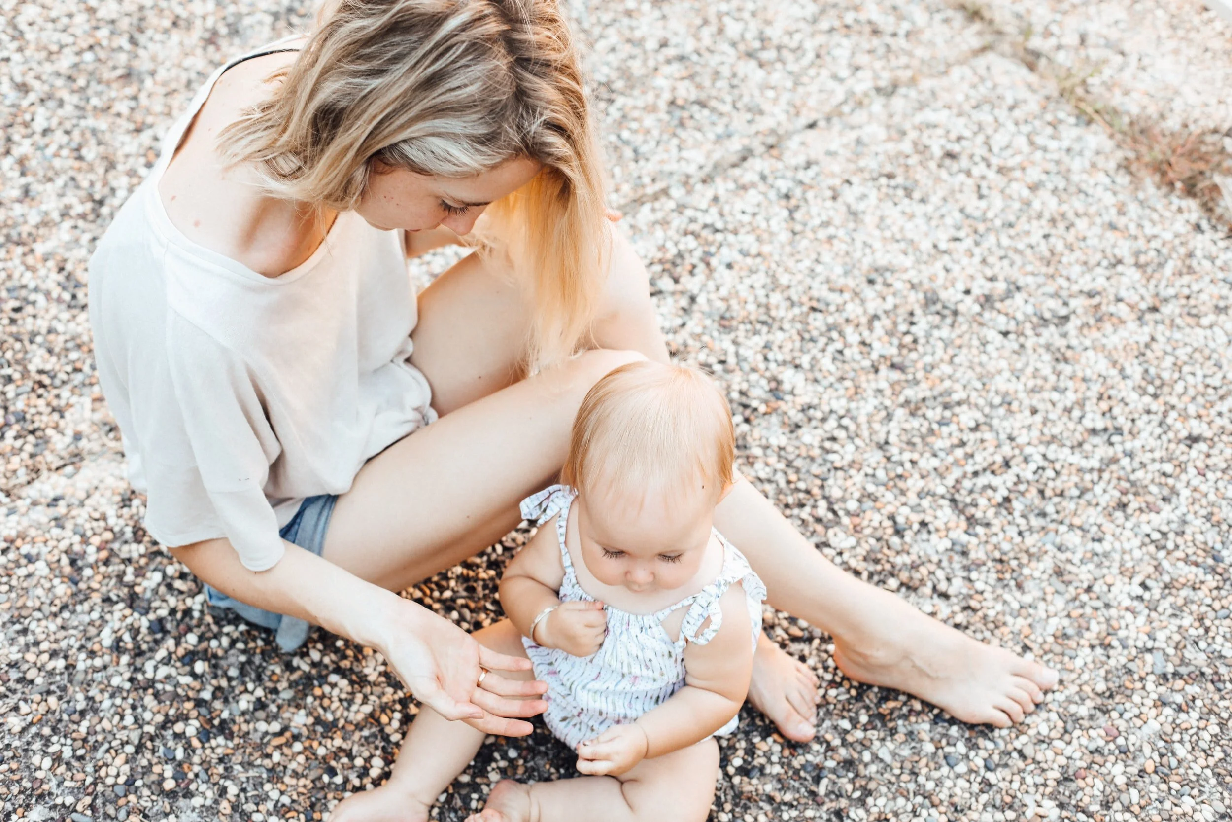  A Mom who is dealing with Postpartum Depression sits with her baby on the ground, after attending counseling at the Heard Counseling with a therapist that works with new Moms and Dads in Miami, Fl.  