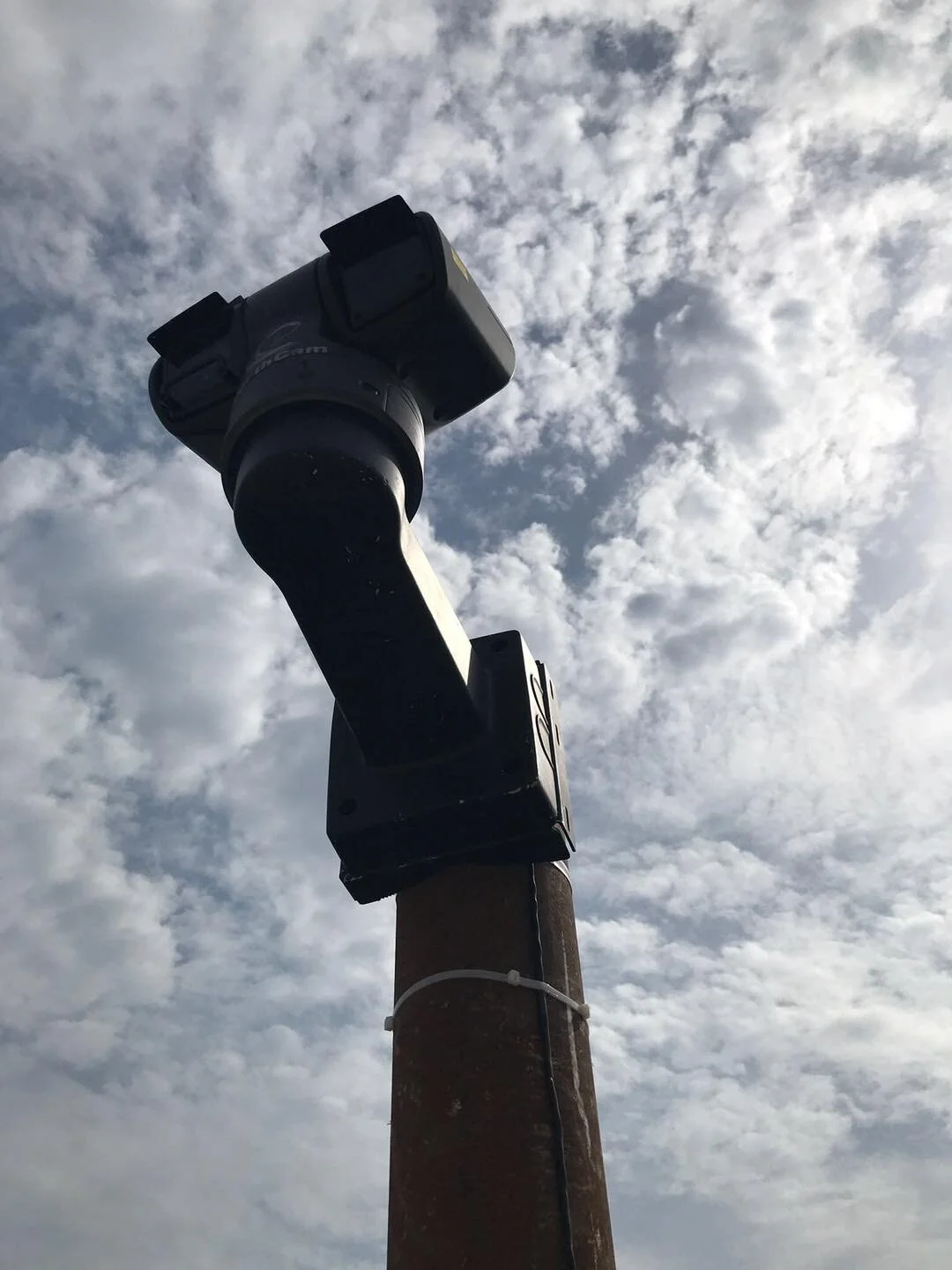 A pole with a 360 degree construction camera mounted on top of a pole for maximum visible of sight