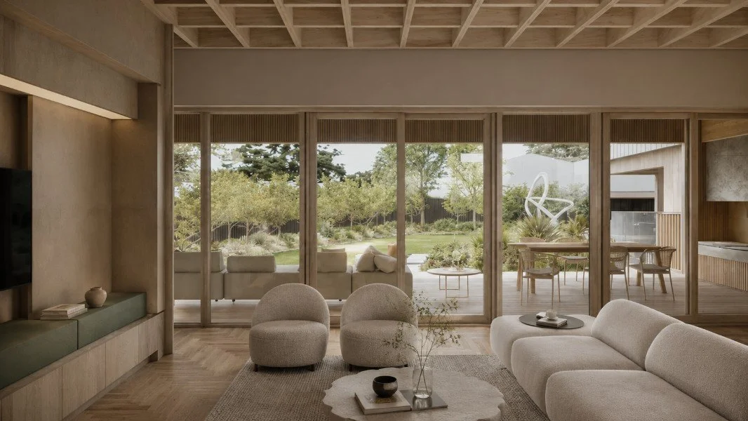 Living room at Estuary House in Mount Martha, with full-height timber-framed glazing opening to a landscaped garden and covered outdoor living area.