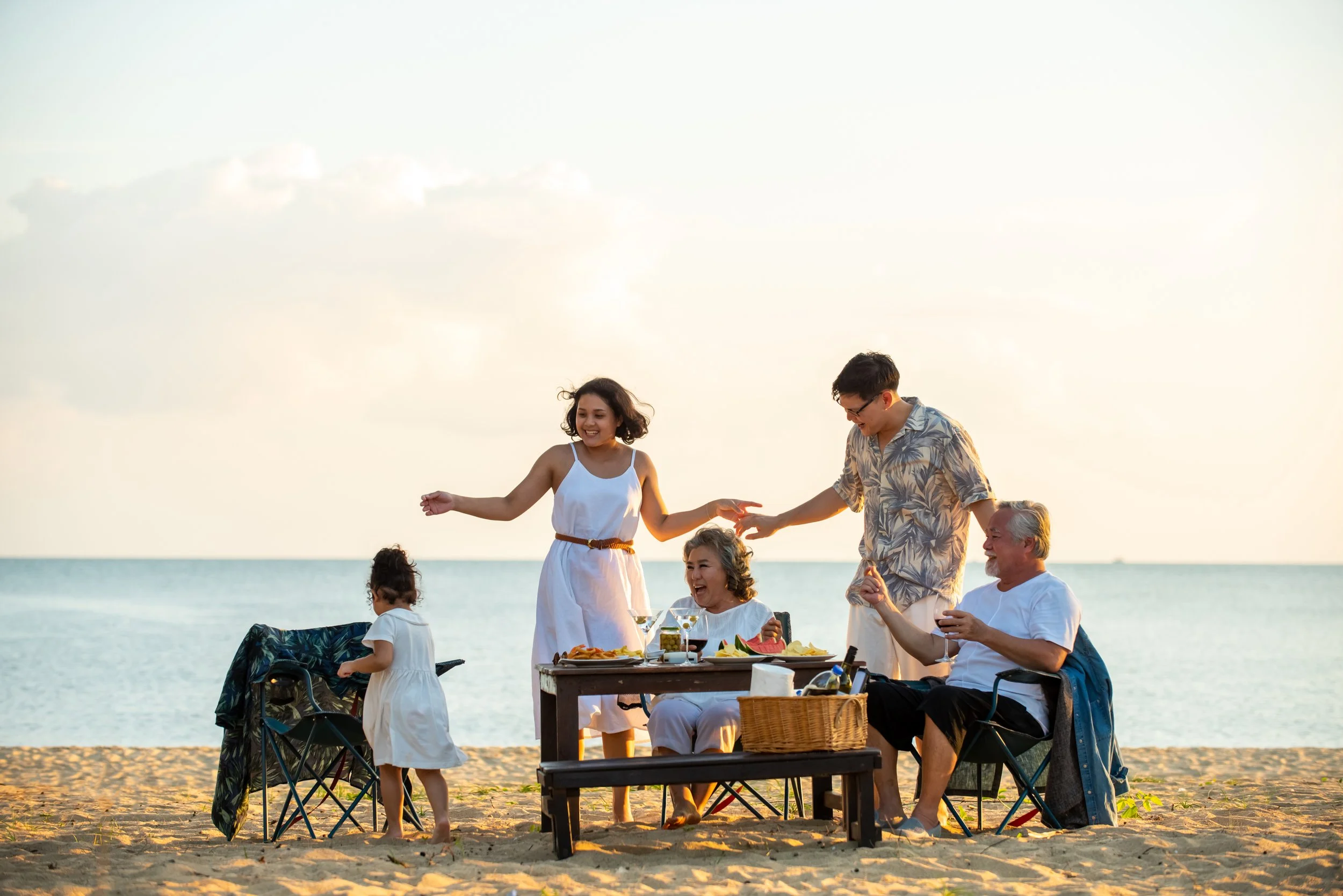 Three generations of a family together at the beach — representing how charitable giving can become part of what a family understands and carries forward together