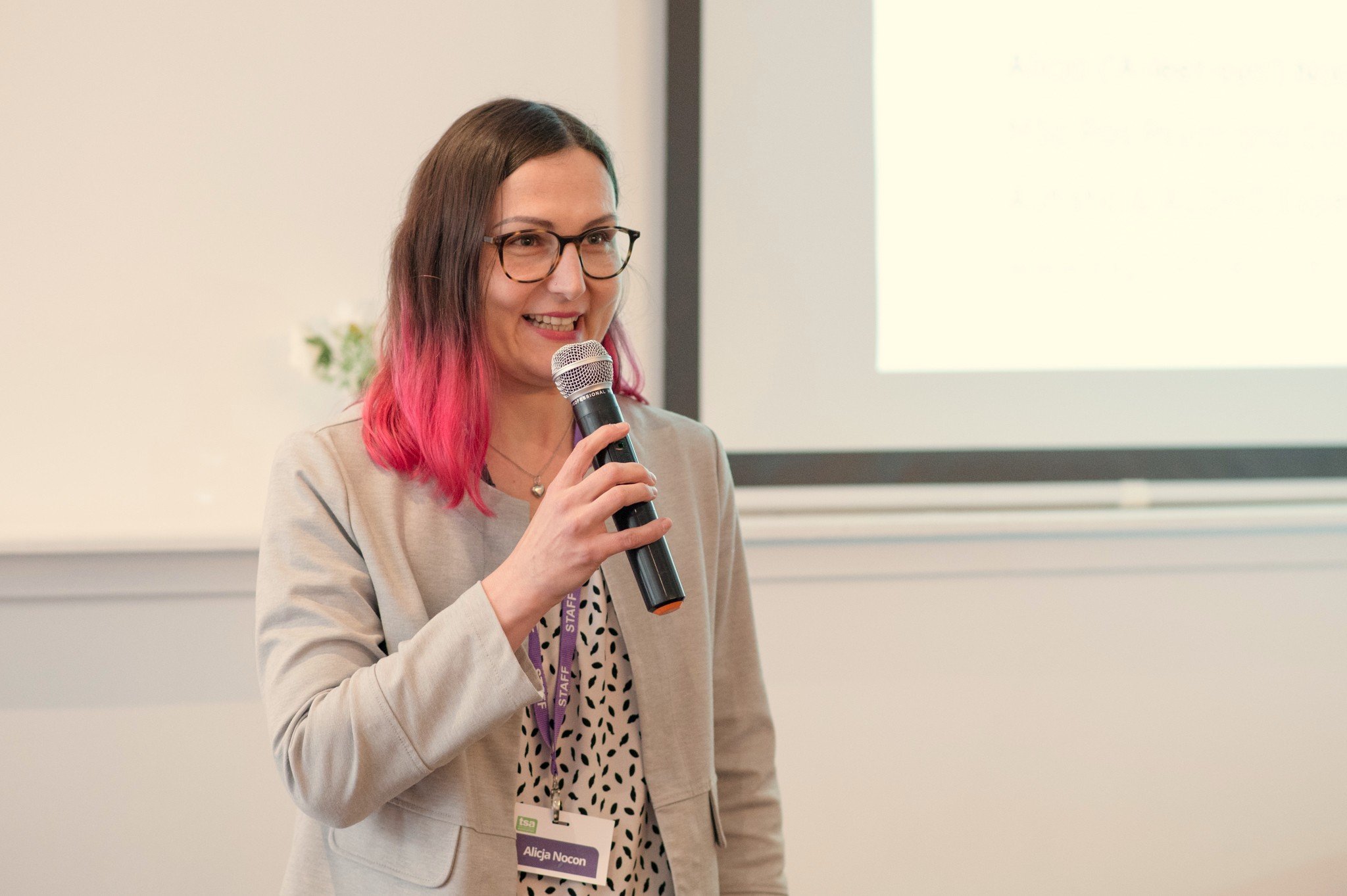 Expand the Circle founder Alicja Nocon holding a microphone and speaking at an event