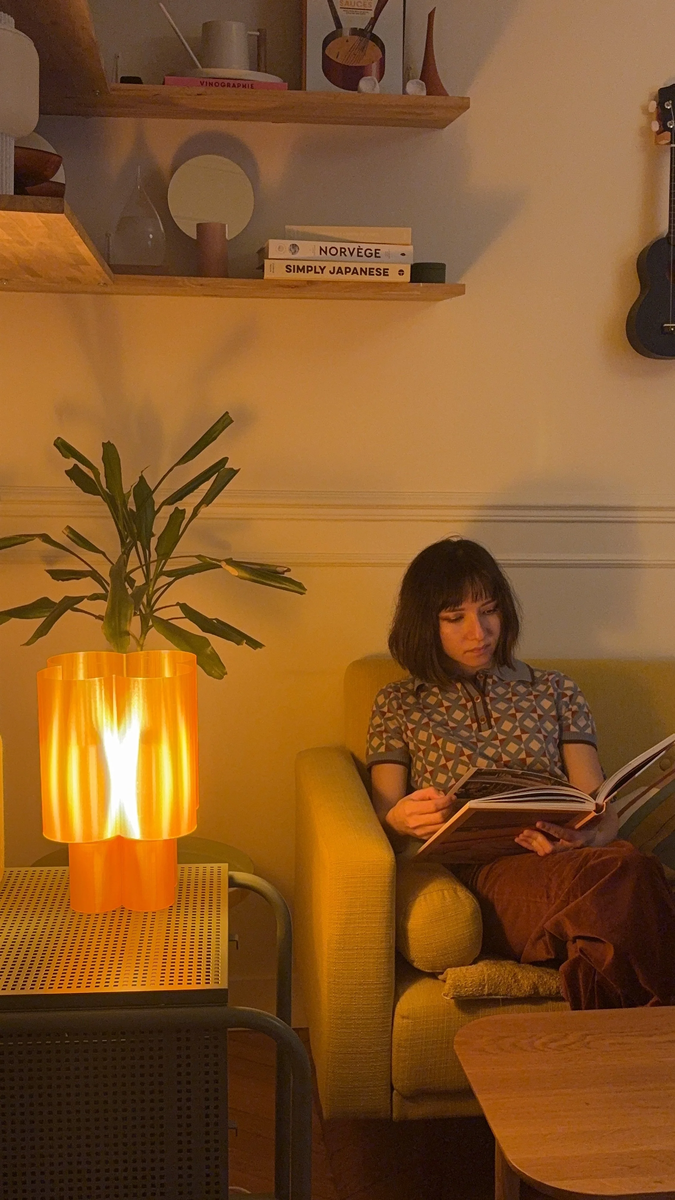 Person relaxing beside the Flower Lamp in a modern living room with contemporary designer furniture.