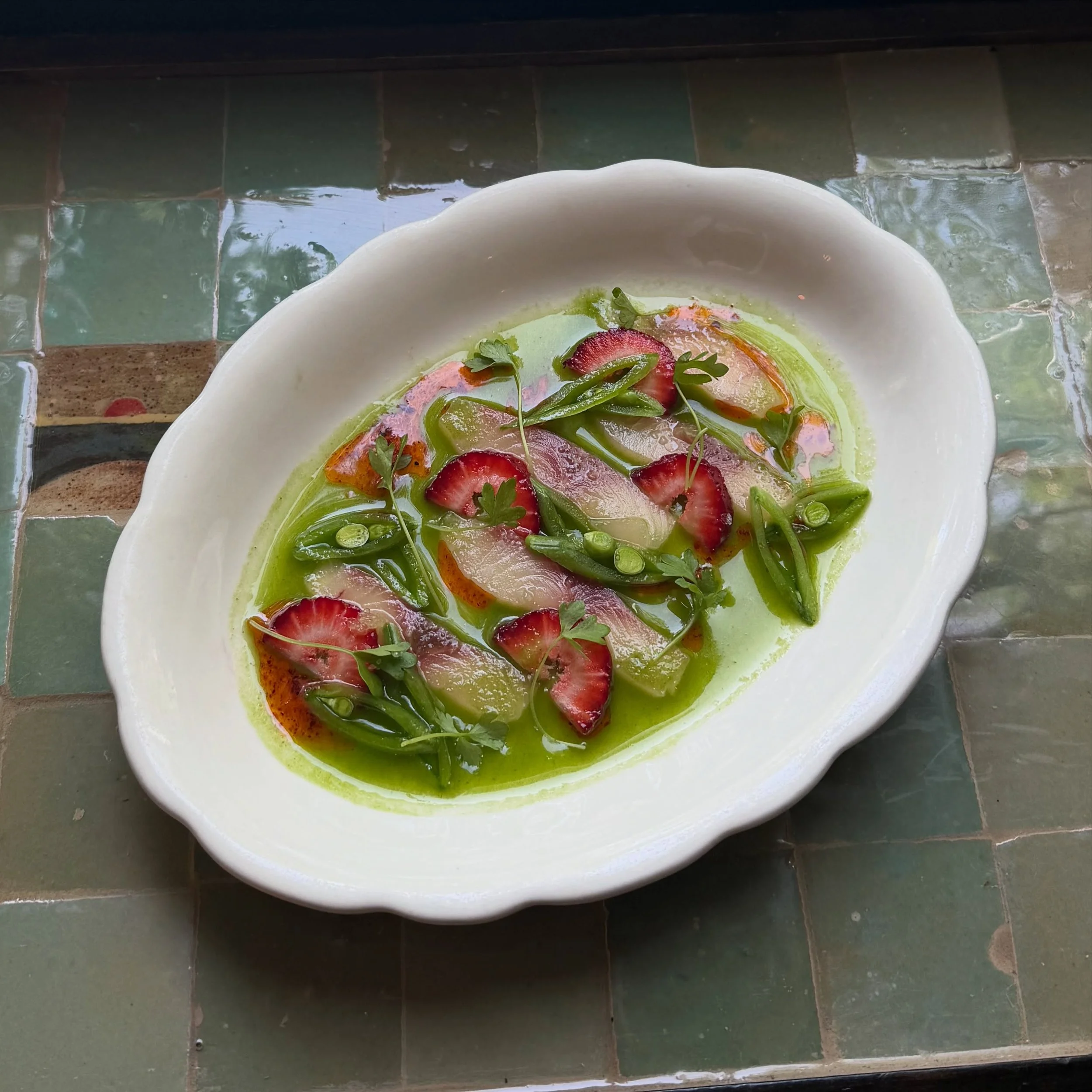 yummmmmyyyyy hamachi crudo, snap pea, strawberry, cucumber parsley juice, finger lime, chili oil, micro celery
