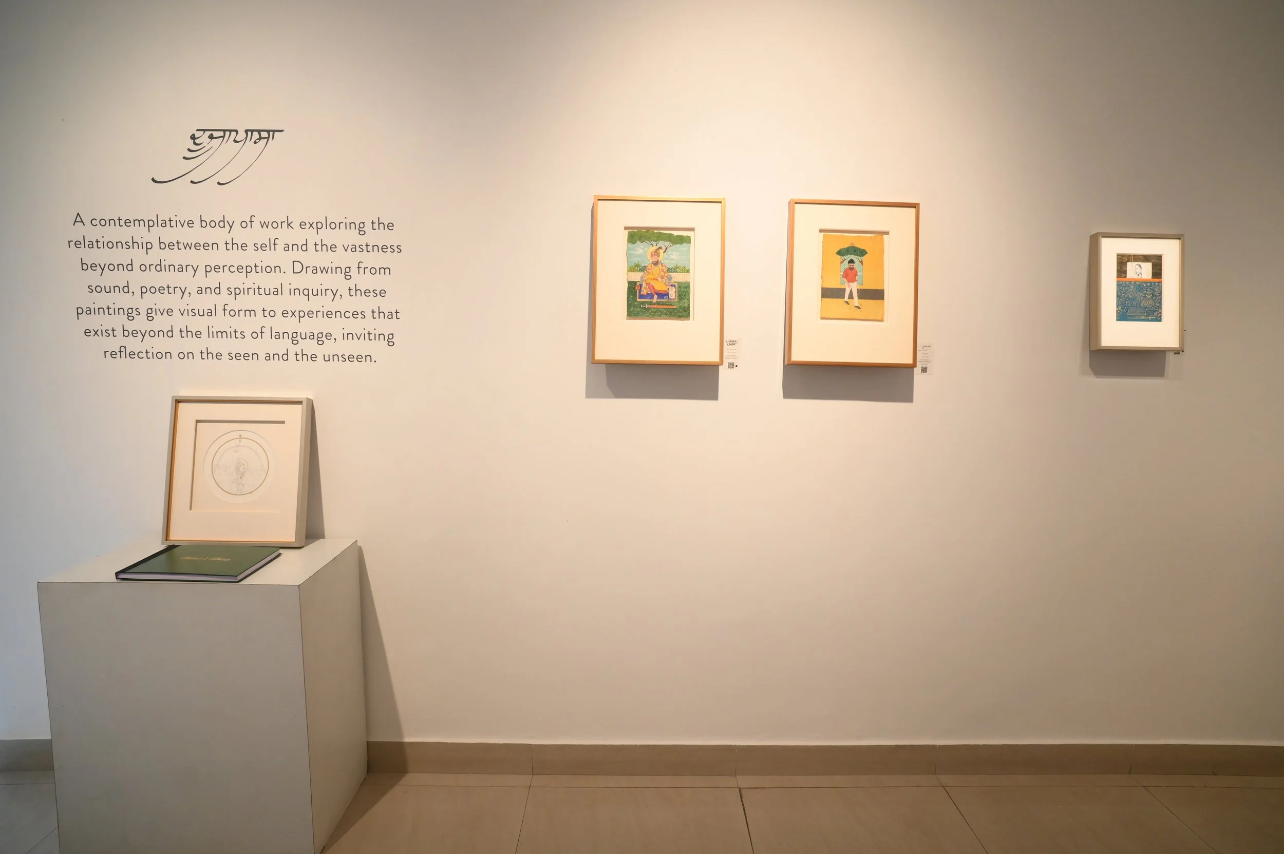Gallery wall featuring four framed artwork pieces with a descriptive text on the left explaining contemplative art exploring the relationship between the self and the vastness beyond perception.