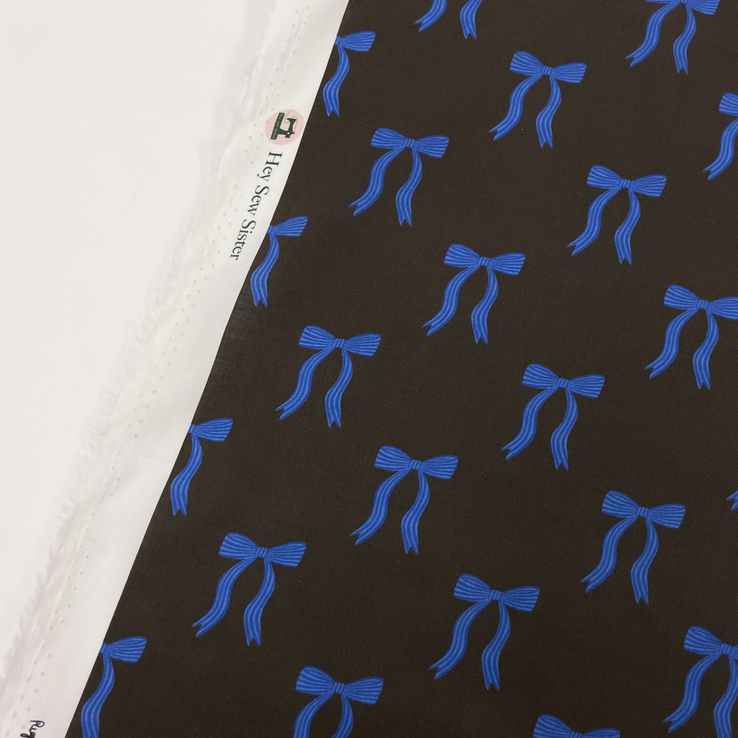 Hey Sew Sister - Pigeon Wishes - Adorn You - Bow Print Fabric - Cotton Lawn Poplin Dressmaking Fabric - Dark Brown and Blue - Cocoa 1.jpeg
