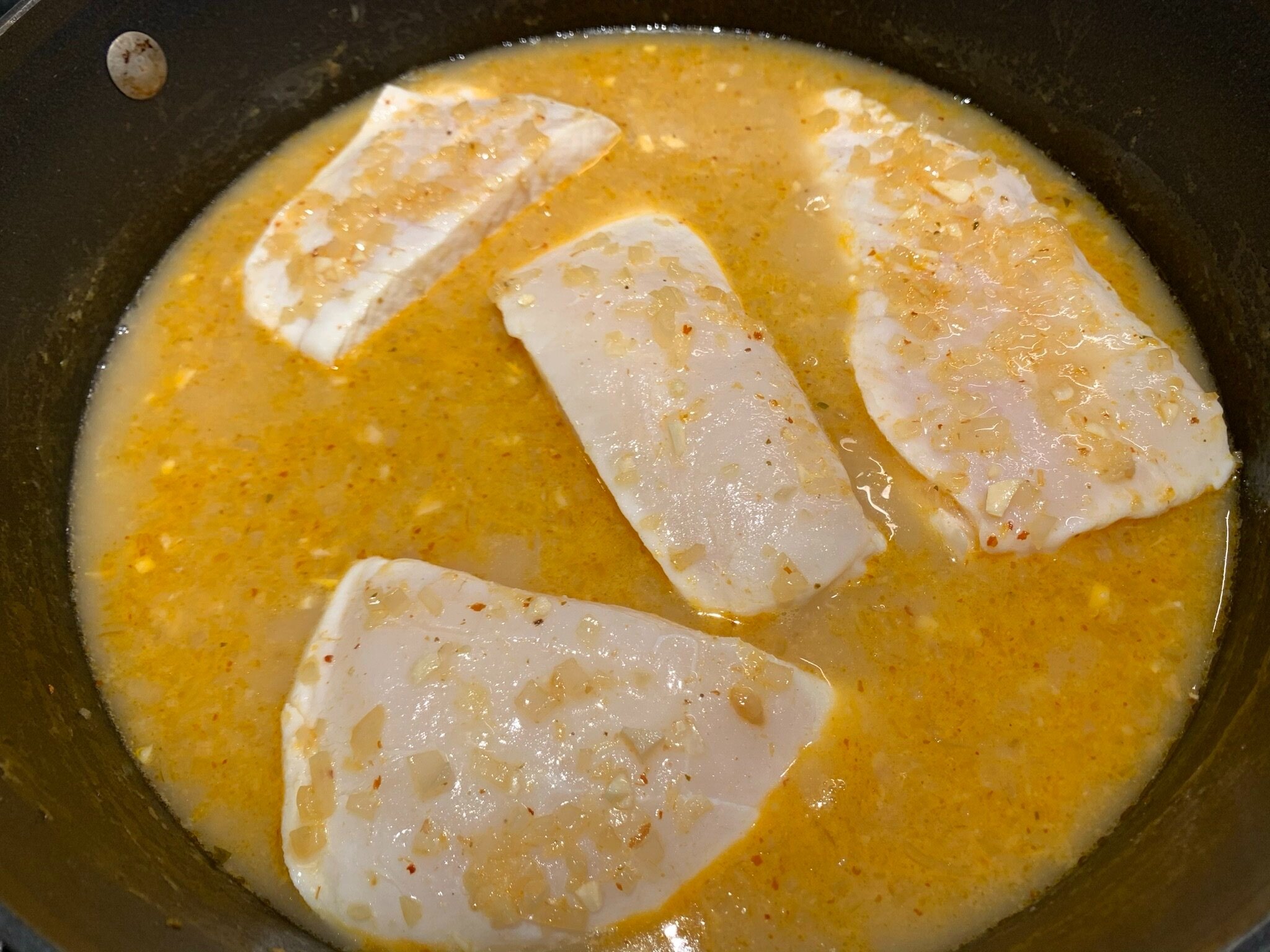 3a) Spoon sauce over fish.