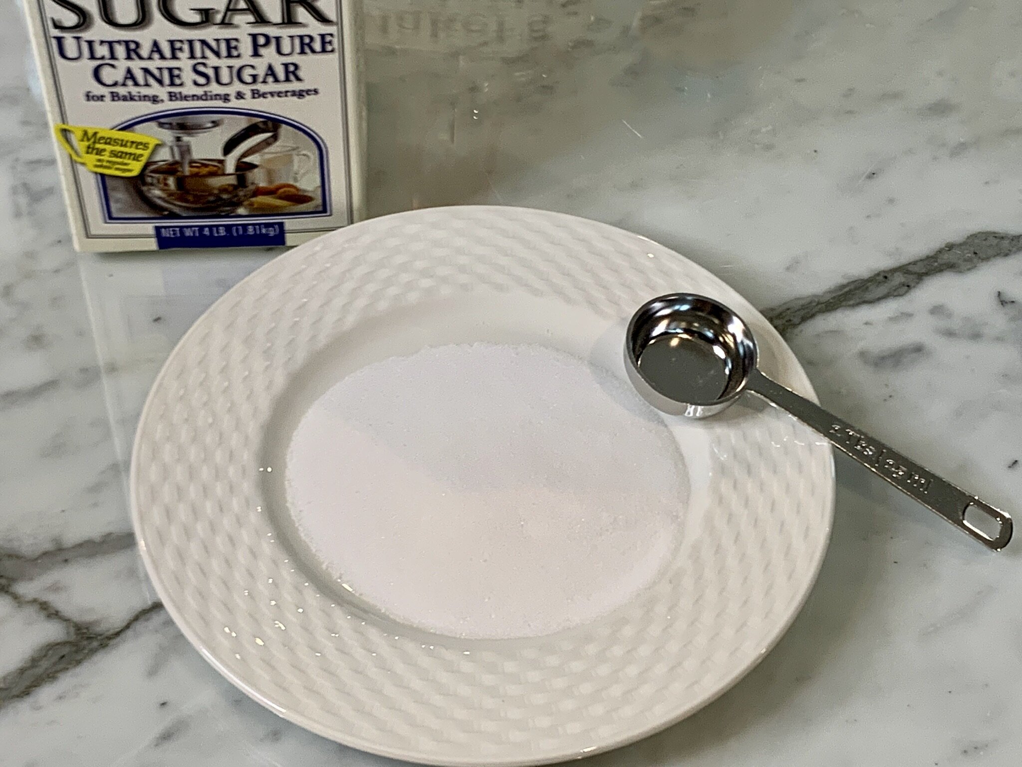Superfine sugar on plate.