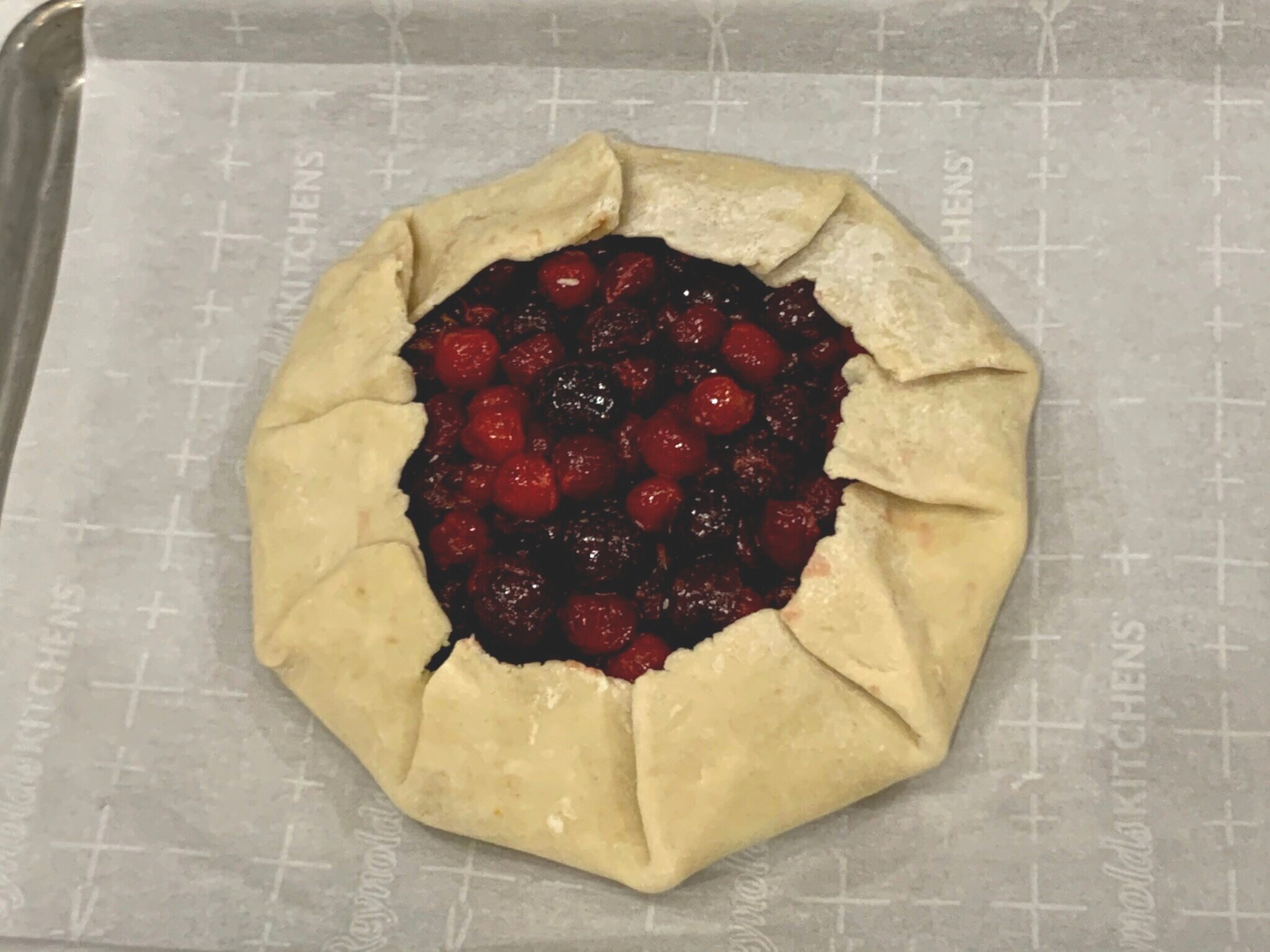 b) Fold crust over cherries.
