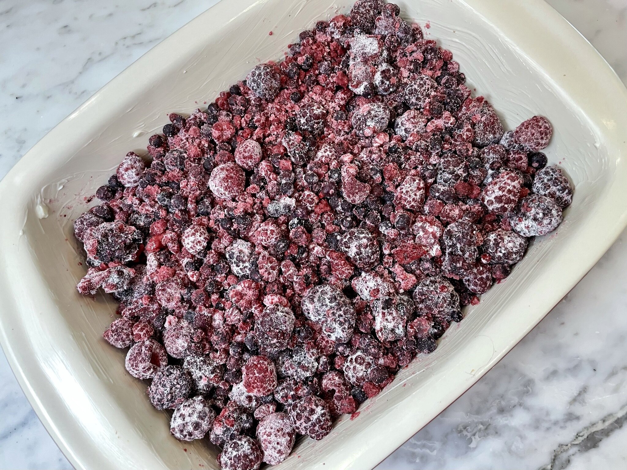 a) Berries into baking pan.