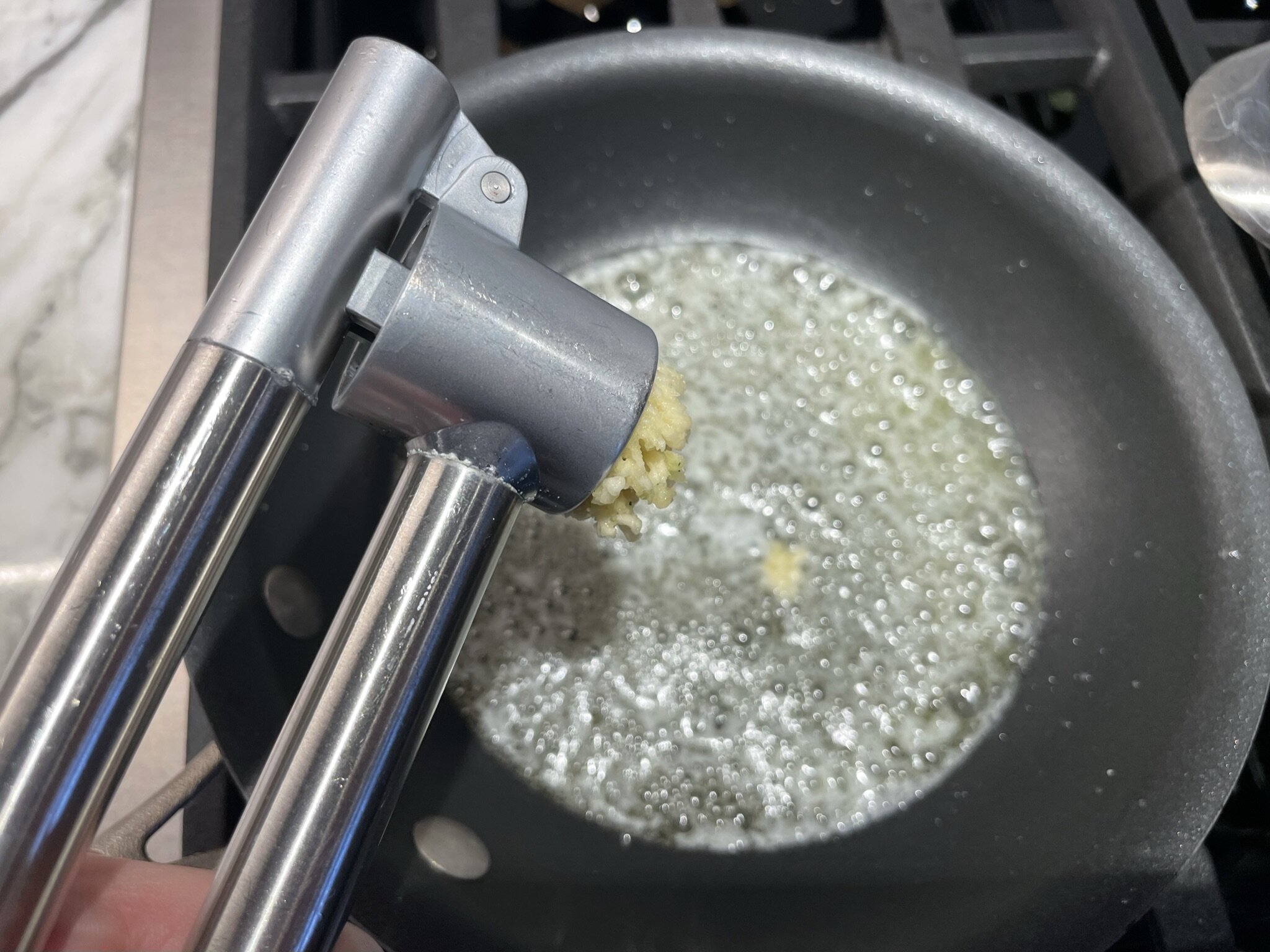 Press garlic into butter.