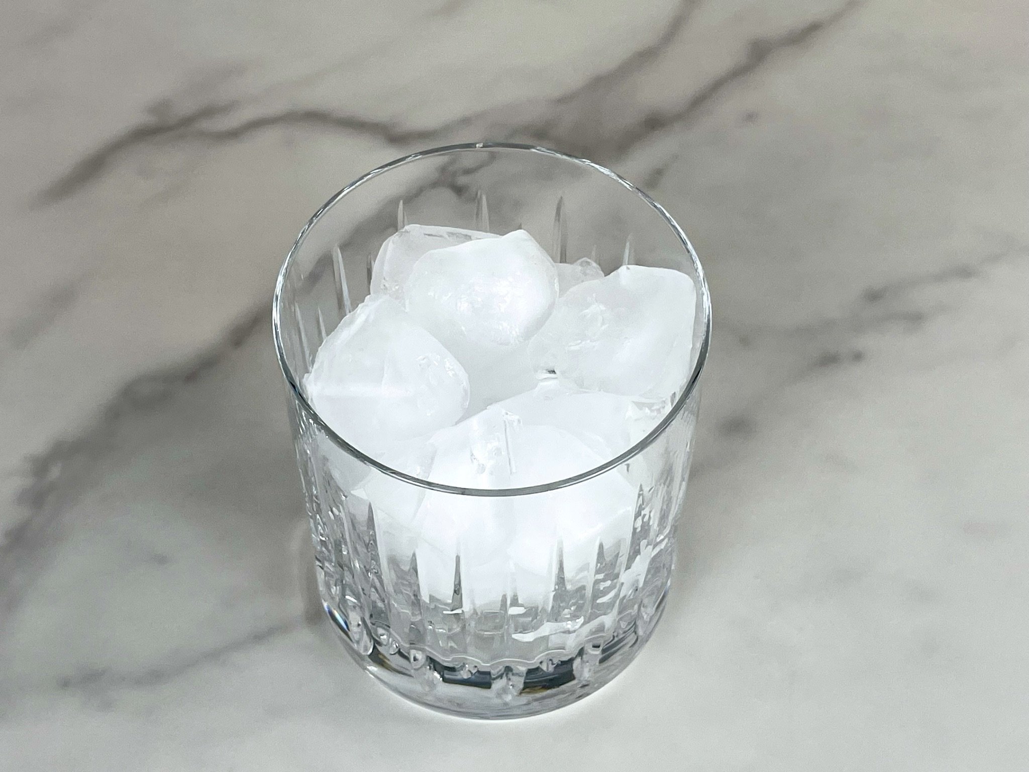 Add ice to a double old fashioned glass.