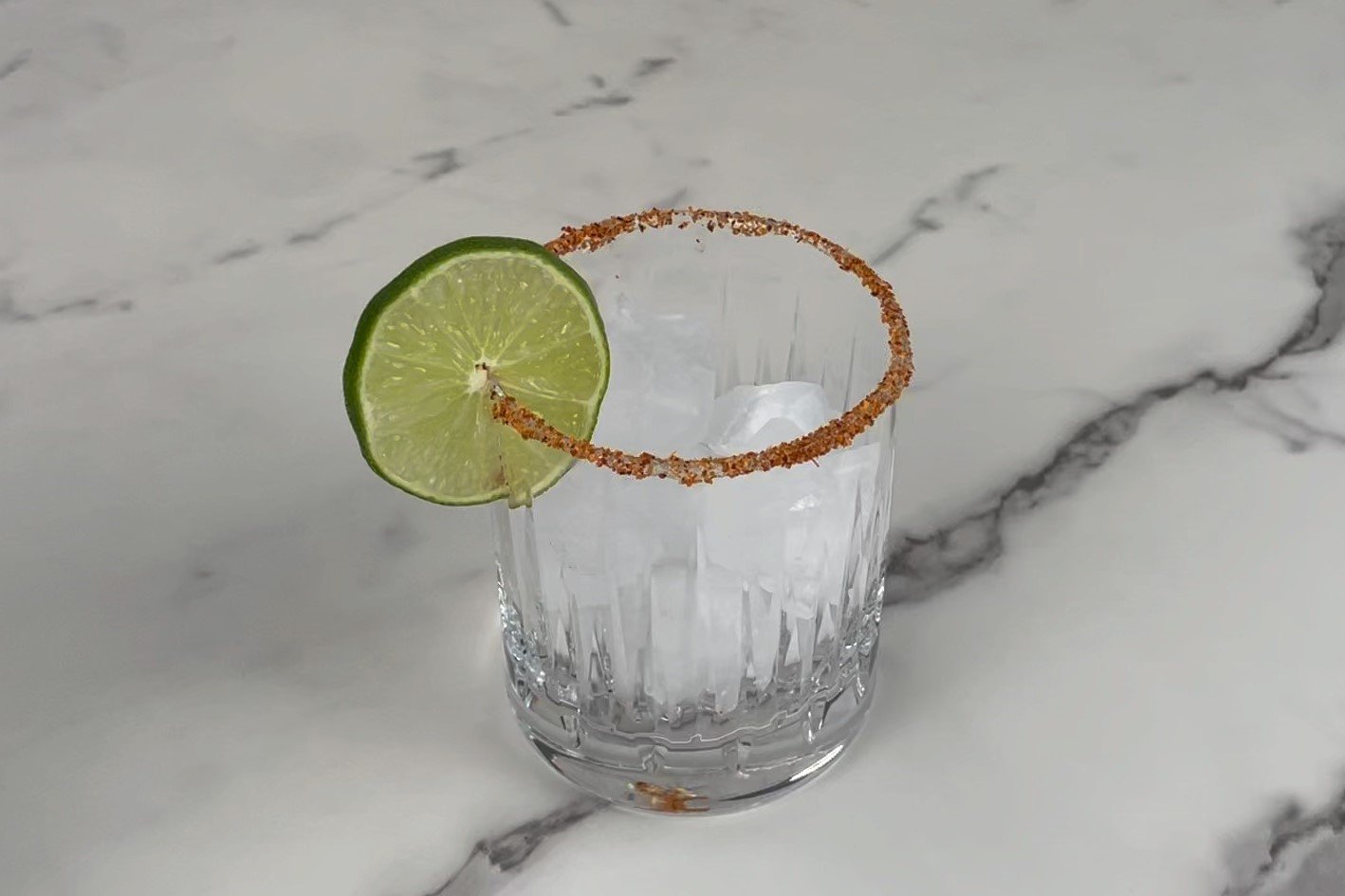 Ice &amp; garnish with lime.