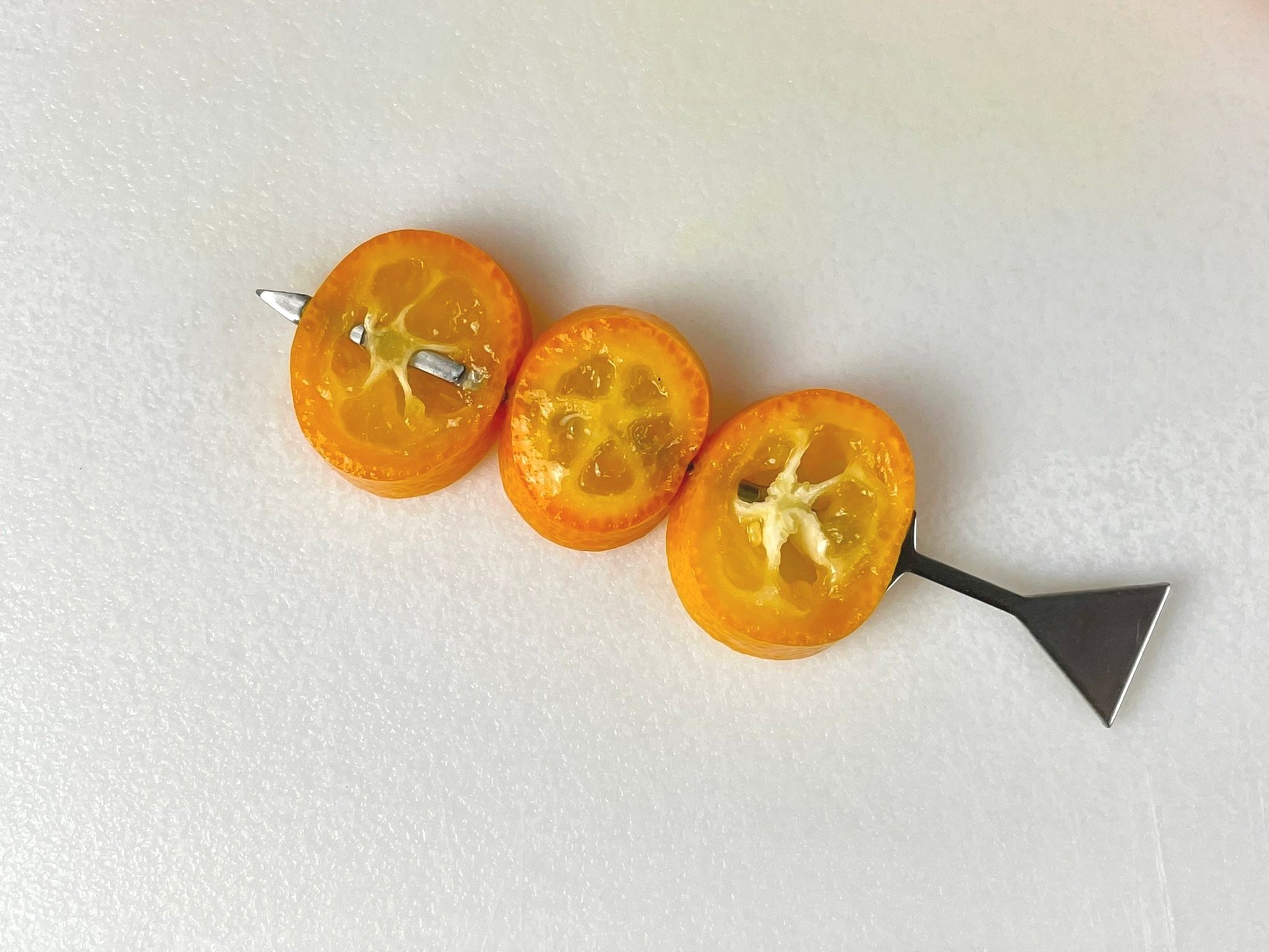 Skewer kumquats.