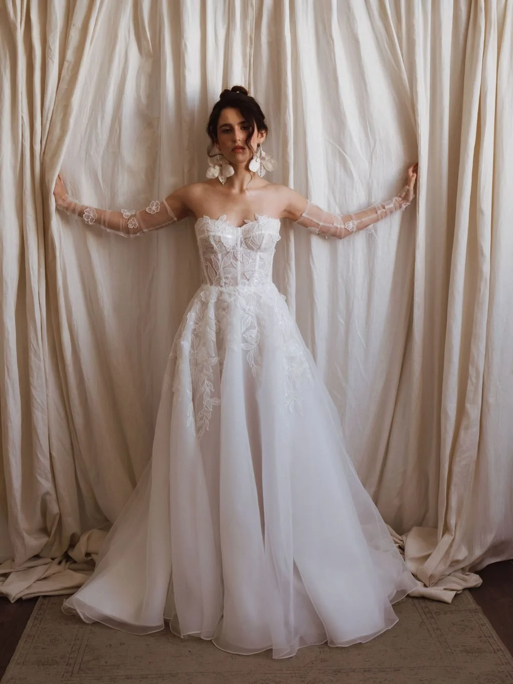 Meet Nissa ✨ from Adriana Madrid!

She&rsquo;s sparkle, structure, and softness all in one. A sculpted corset that snatches perfectly, an airy A-line skirt that floats effortlessly, and the prettiest shimmer floral details that melt down the gown lik