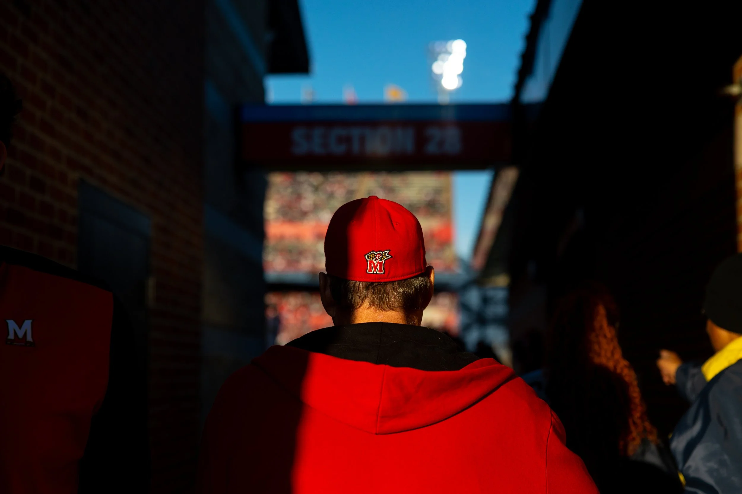 A fan wearing Maryland merch walks into SECU Stadium during the Terps's homecoming football game against Indiana University on Nov. 1, 2025.