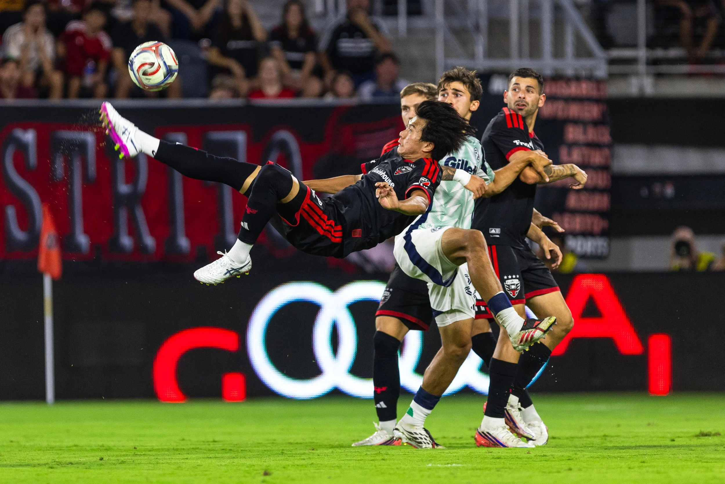 Kimito Nono bicycle kicks a shot on goal during DC United's 3-0 loss to New England at Audi Field in Washington, D.C., on Aug. 19, 2026.