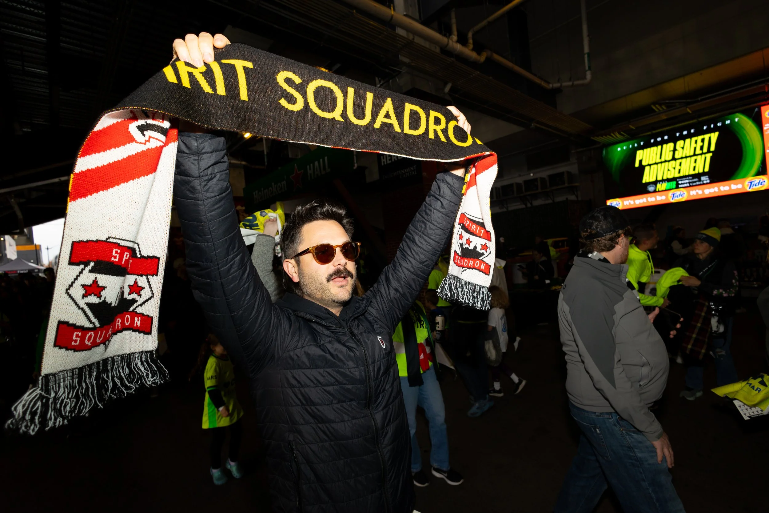 A member of the Spirit Squadron walks down Heineken Hall ahead of the Spirit's semifinal match against the Portland Thorns at Audi Field on Nov. 15, 2025. The Spirit won 2-0, sending them to their second straight NWSL appearance.