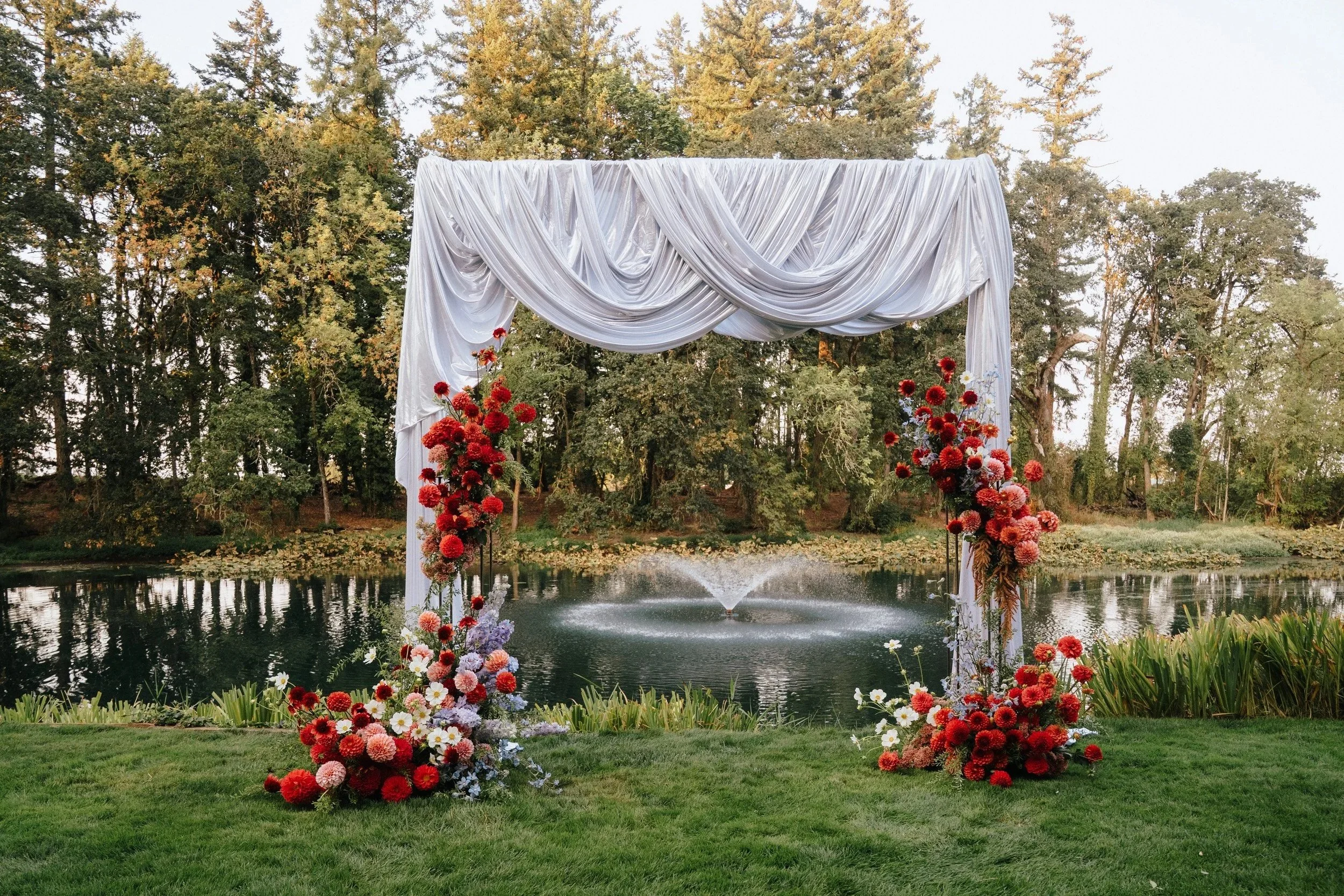 Riverside ceremony site with structural florals at Gardens at Riverside wedding venue