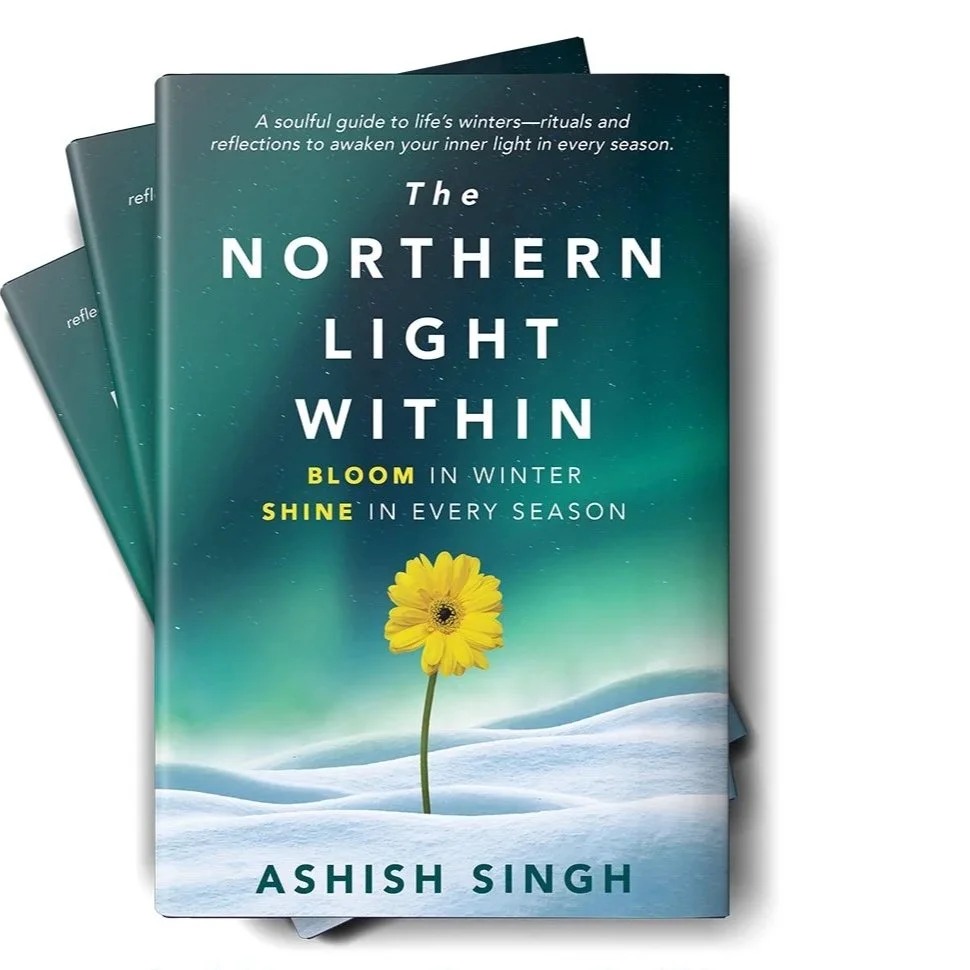 Cover of a book titled 'The Northern Light Within' by Ashish Singh. The cover features a yellow flower on snow with a green and blue gradient sky background.