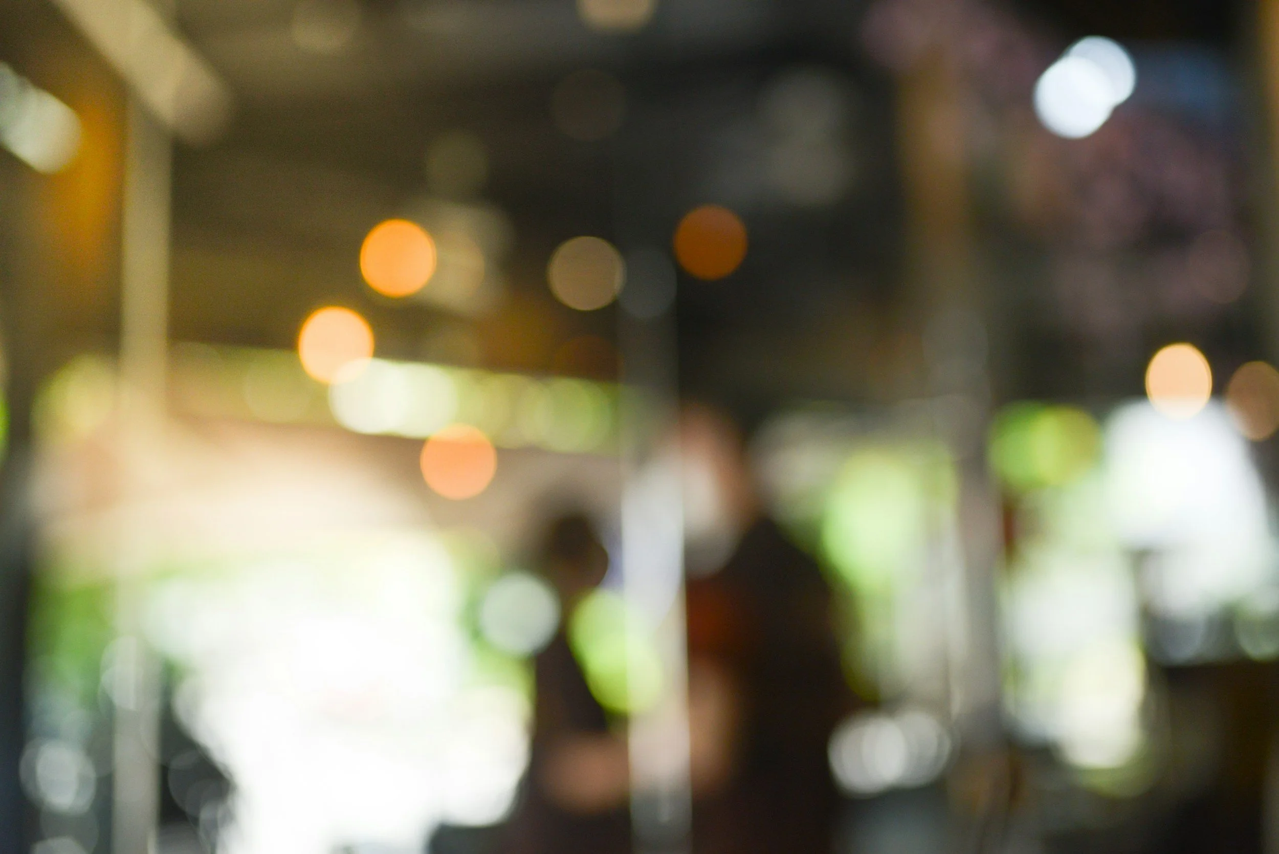 Blurry image of city lights at night with bokeh effect.