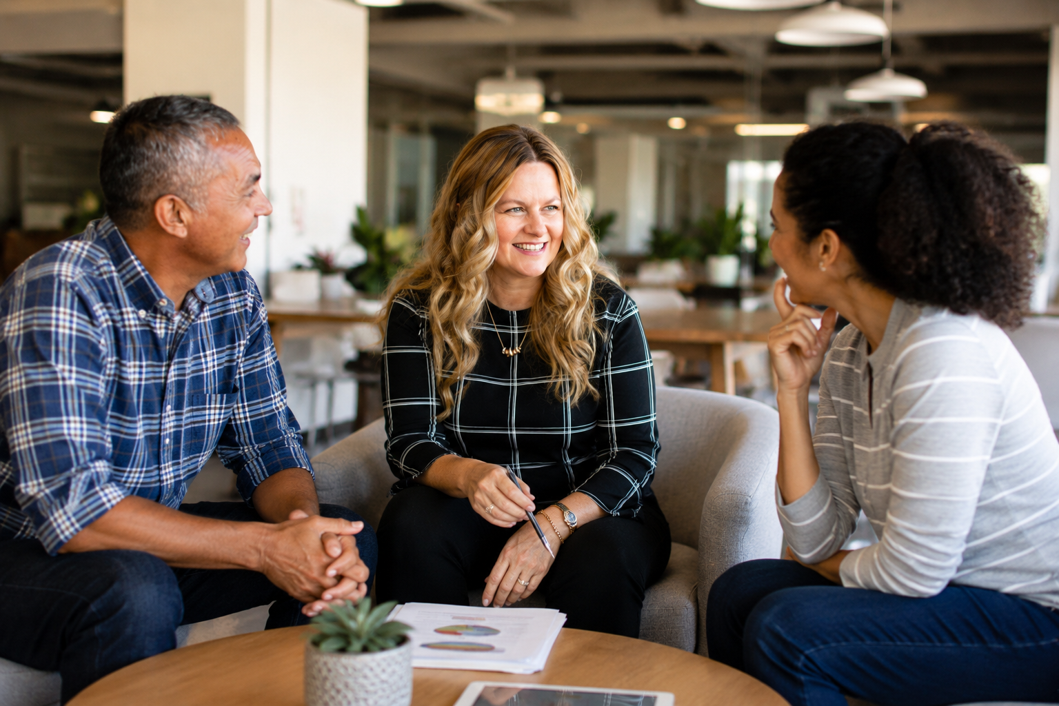 Financial controller meeting with business owners to review financial reports and discuss business performance in a collaborative office setting.