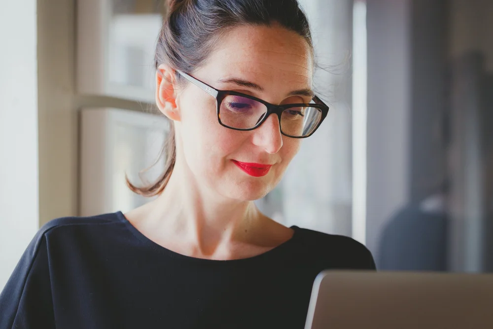 A woman browsing on a laptop