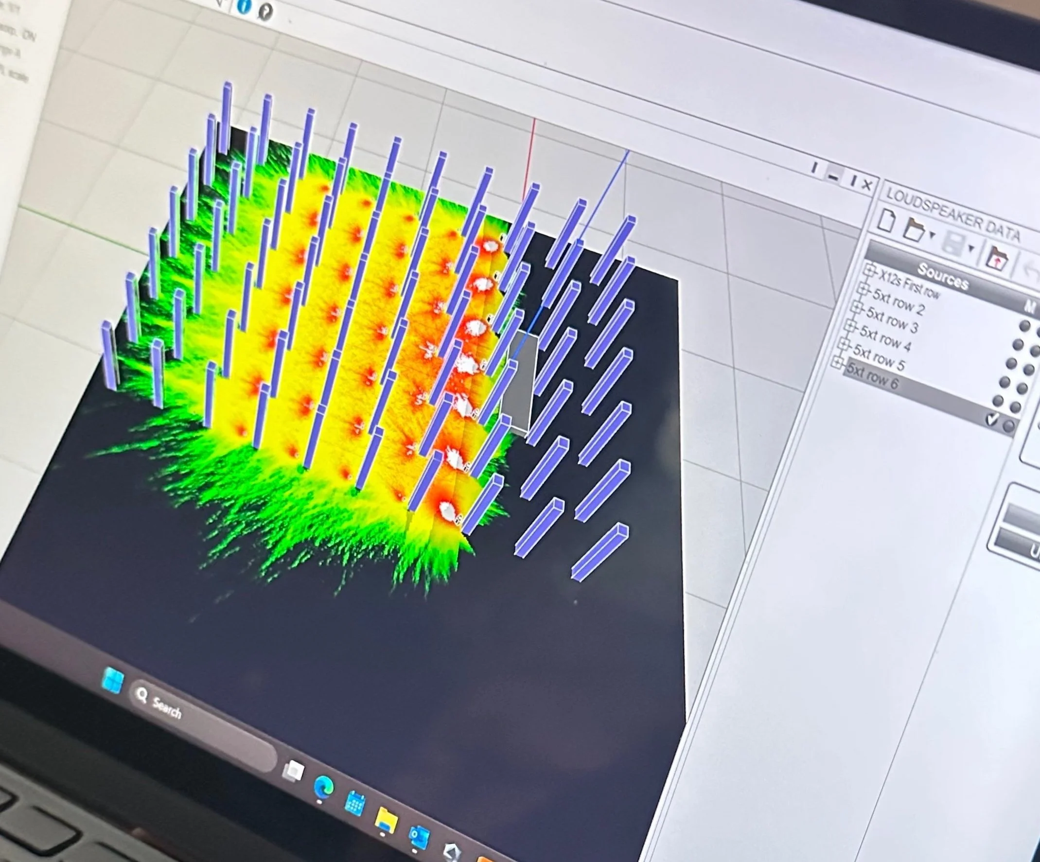 A computer screen displaying a 3D sound wave analysis with colorful wave patterns and vertical bars.