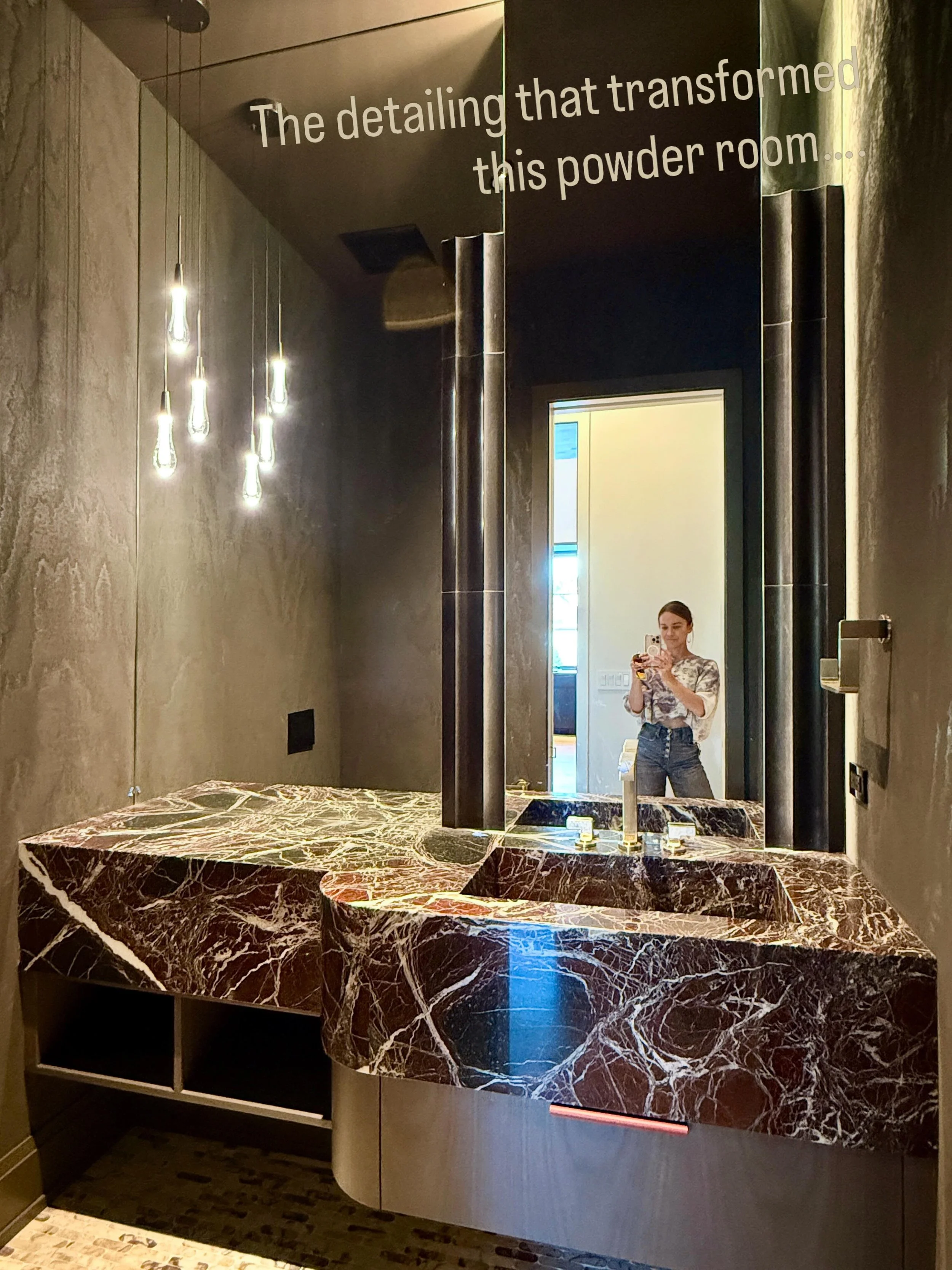 The detailing we brought to this powder room vanity is what really makes the space:

&bull; The exaggerated stone thickness immediately draws your attention and allows the dramatic Pinot Noir Marble selection to fully stand out.
&bull; The curved edg
