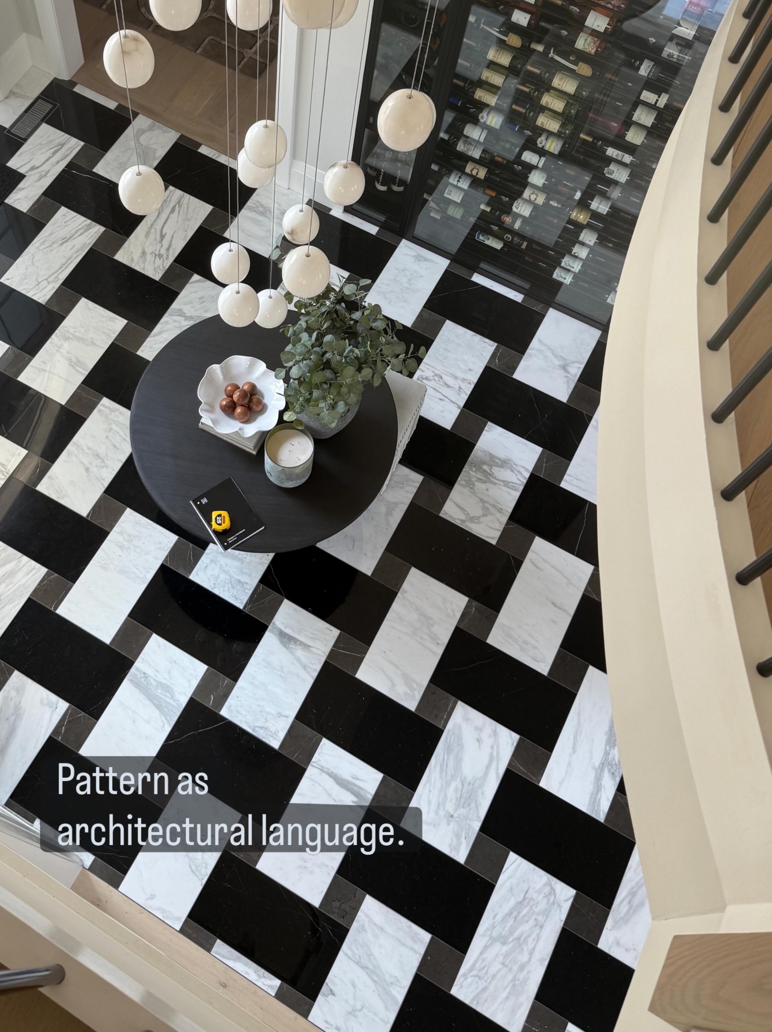 Somehow, we made it through the professional photo shoot without fully capturing the scale of this custom marble tile installation. 

Thankfully, one overhead iPhone photo survived.

Designed as a large-scale geometric flooring pattern, the marble in