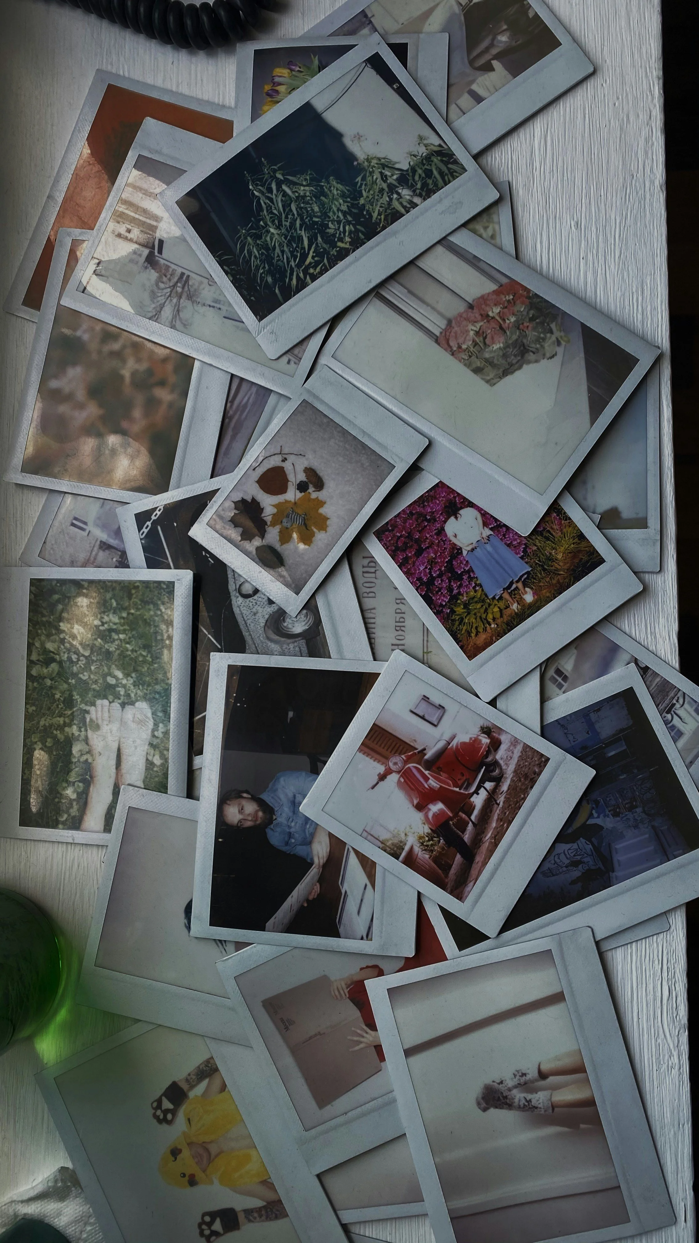 A disorganized pile of photos on a table
