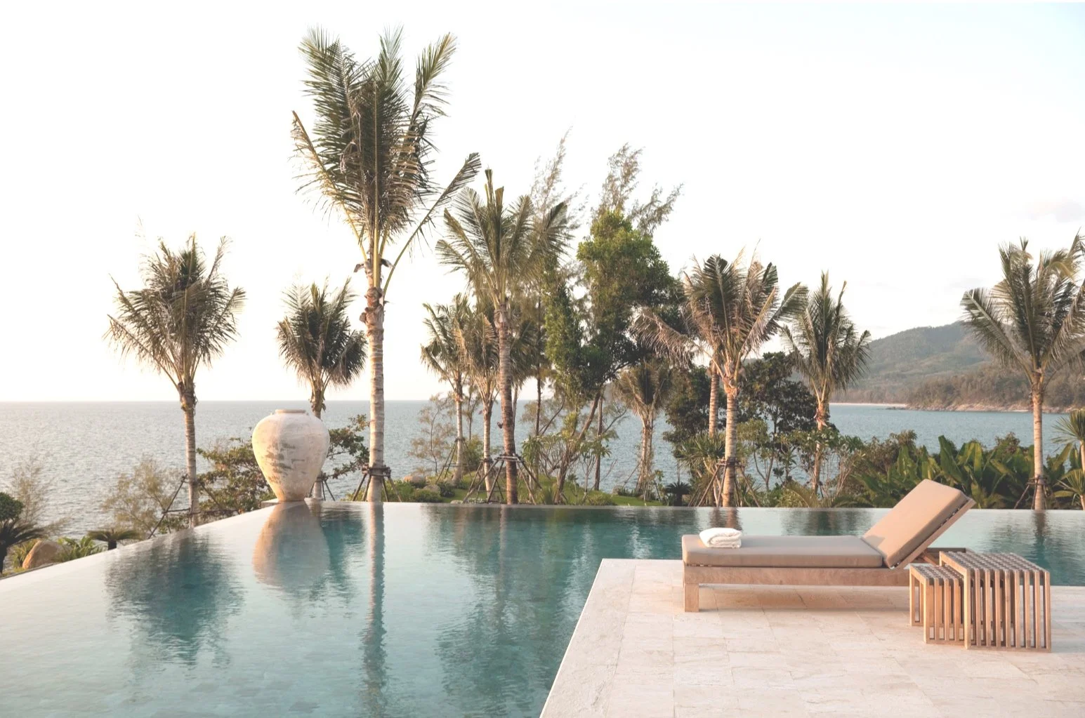 Infinity pool with palm trees overlooking Los Cabos ocean