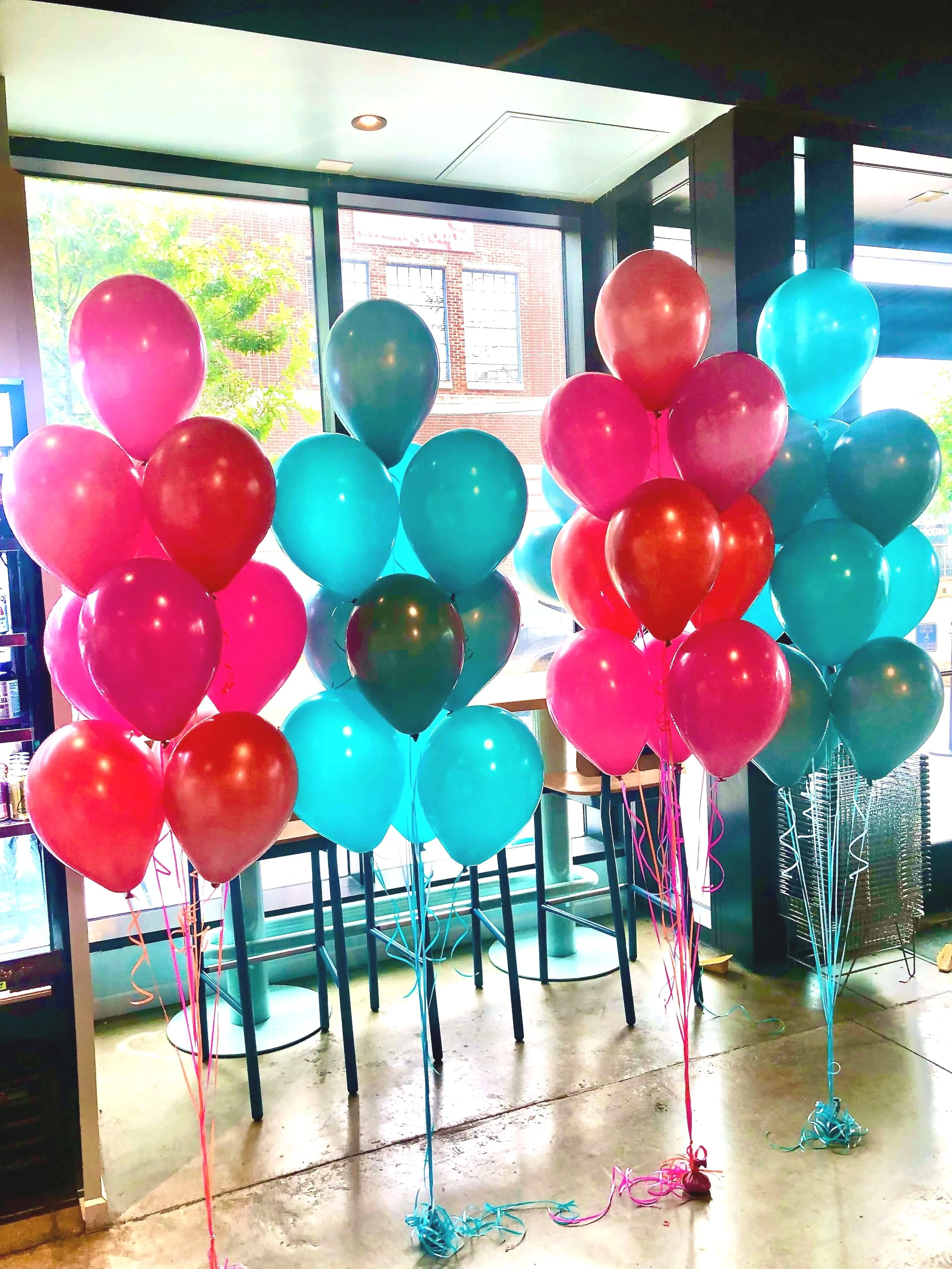 Bright helium balloon bouquets for Salted Melon’s corporate 1-year anniversary celebration, displayed indoors.