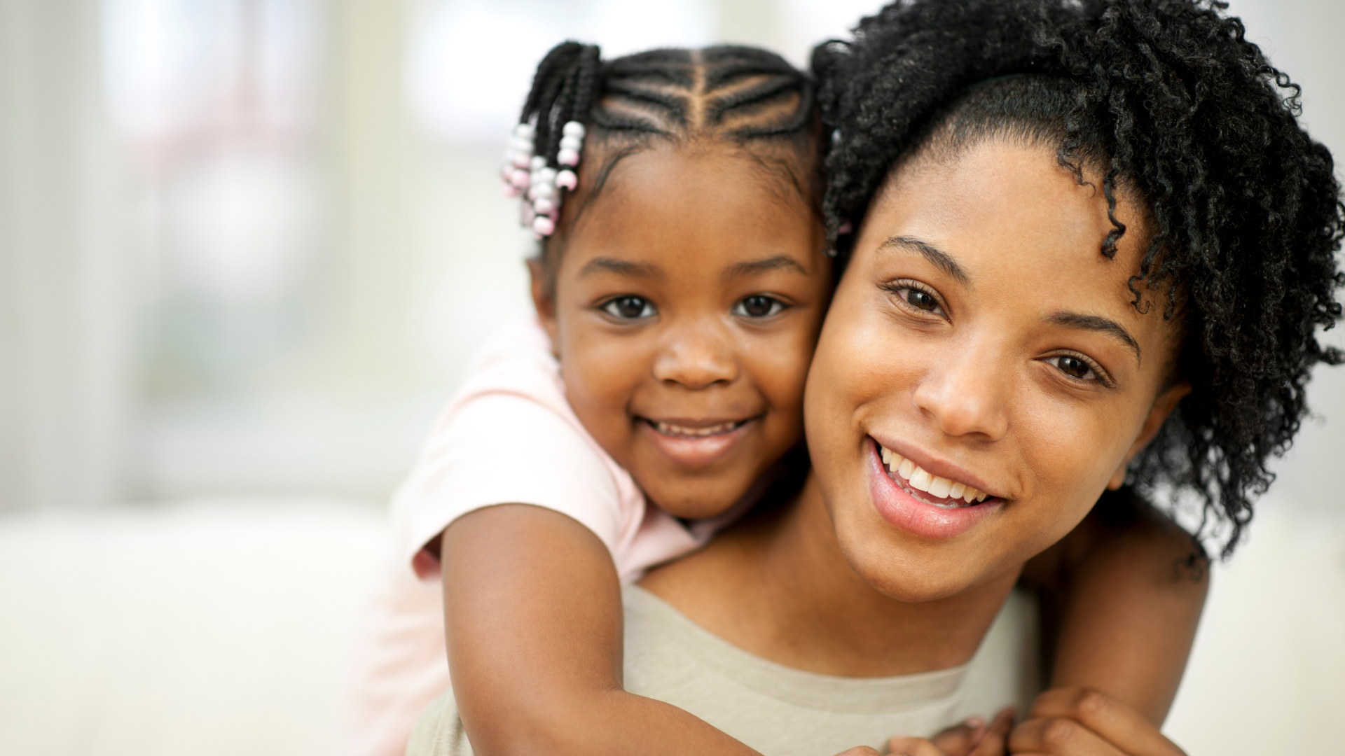 Mother and daughter smiling together